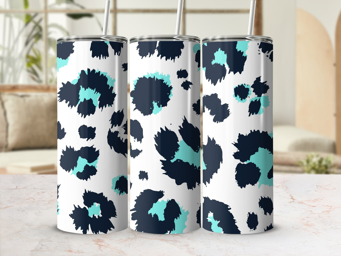 Three tumblers with navy and teal leopard print on white.