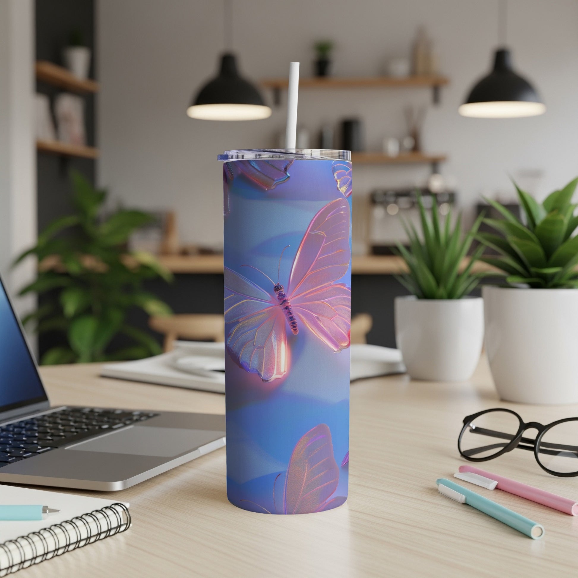 Blue iridescent tumbler with holographic butterfly pattern and white straw.