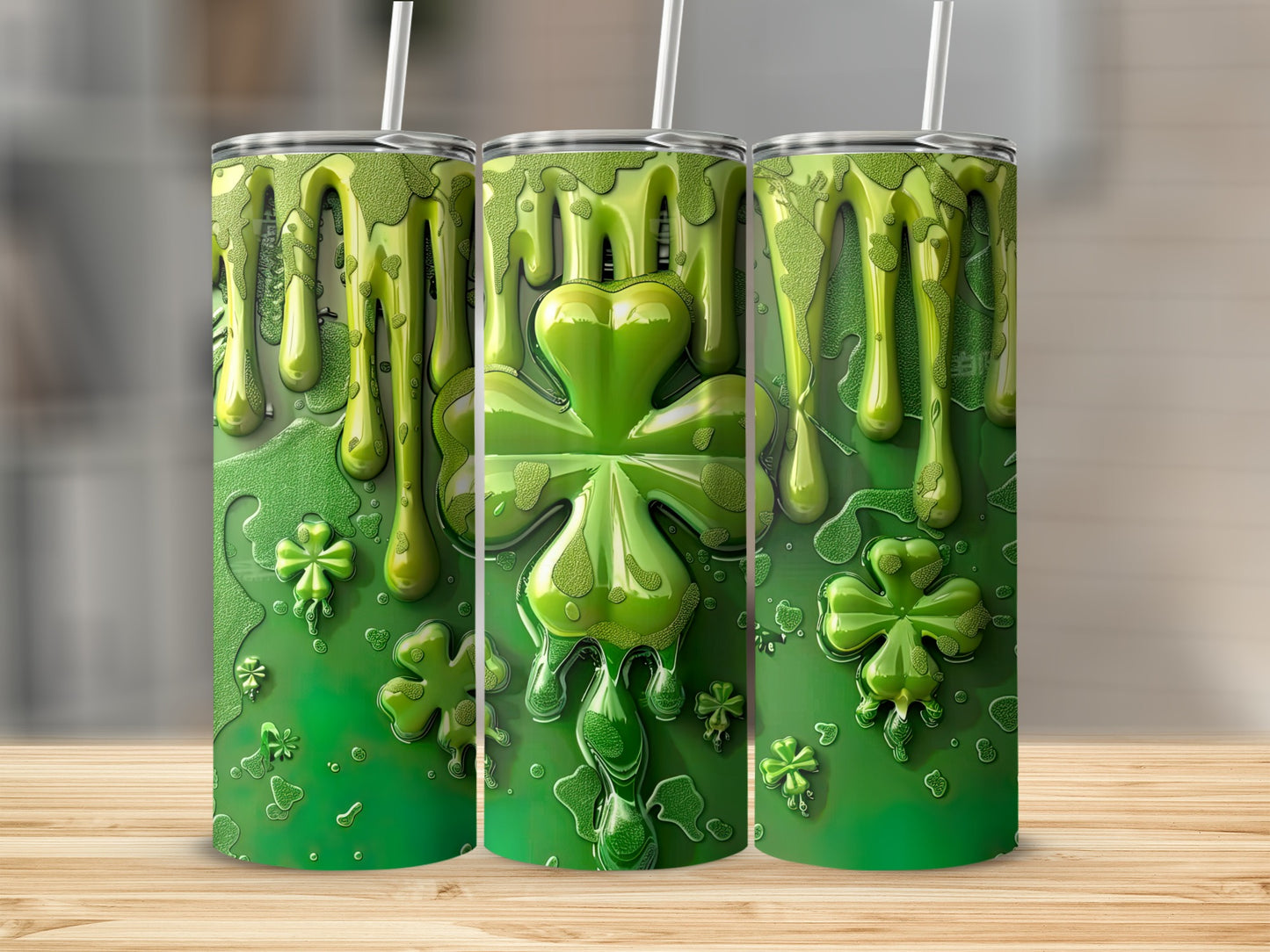Three green tumblers with a shamrock and dripping slime design.
