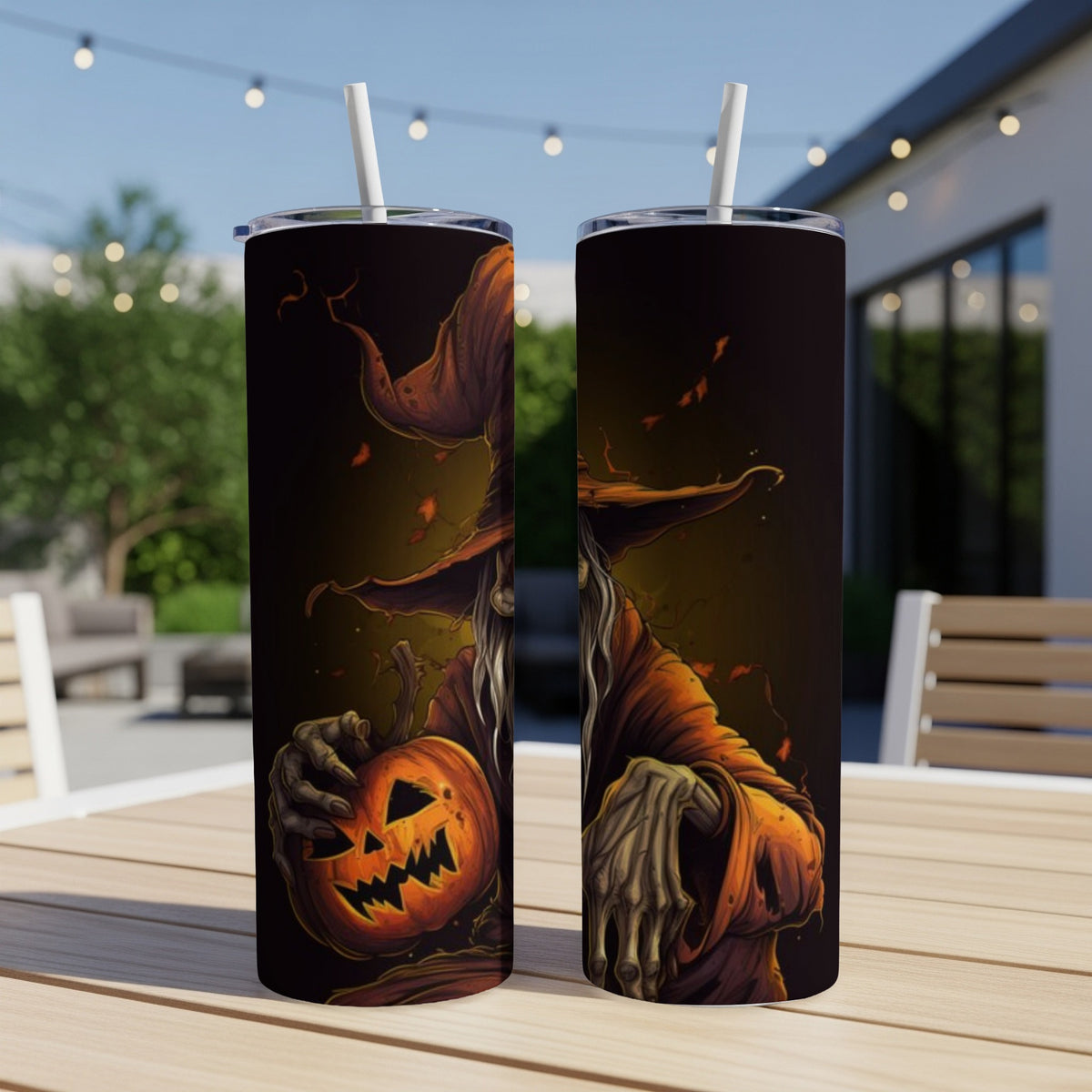 Two tumblers featuring a spooky witch holding a jack-o'-lantern.