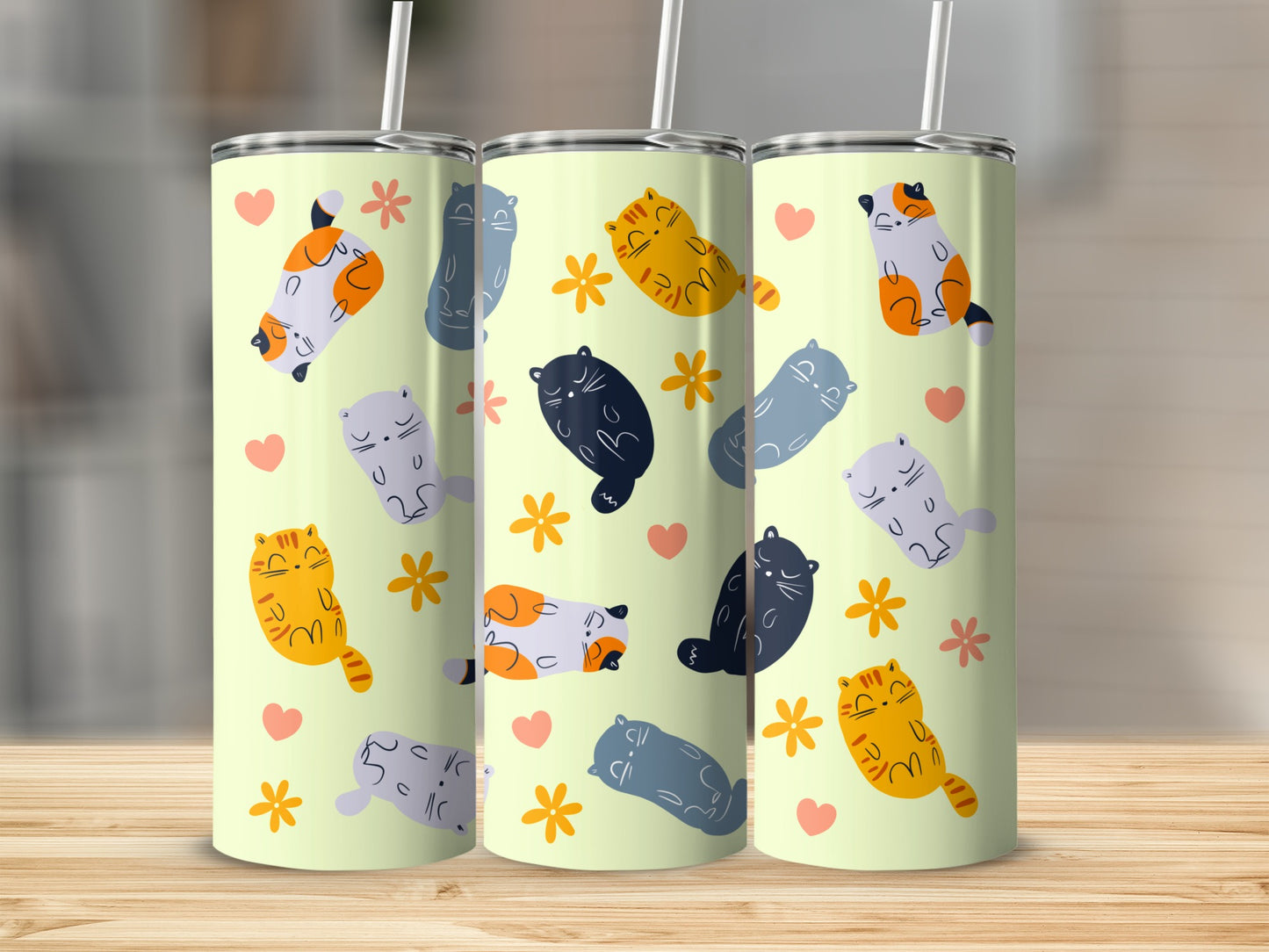 Three light yellow tumblers with repeating cat and flower pattern.