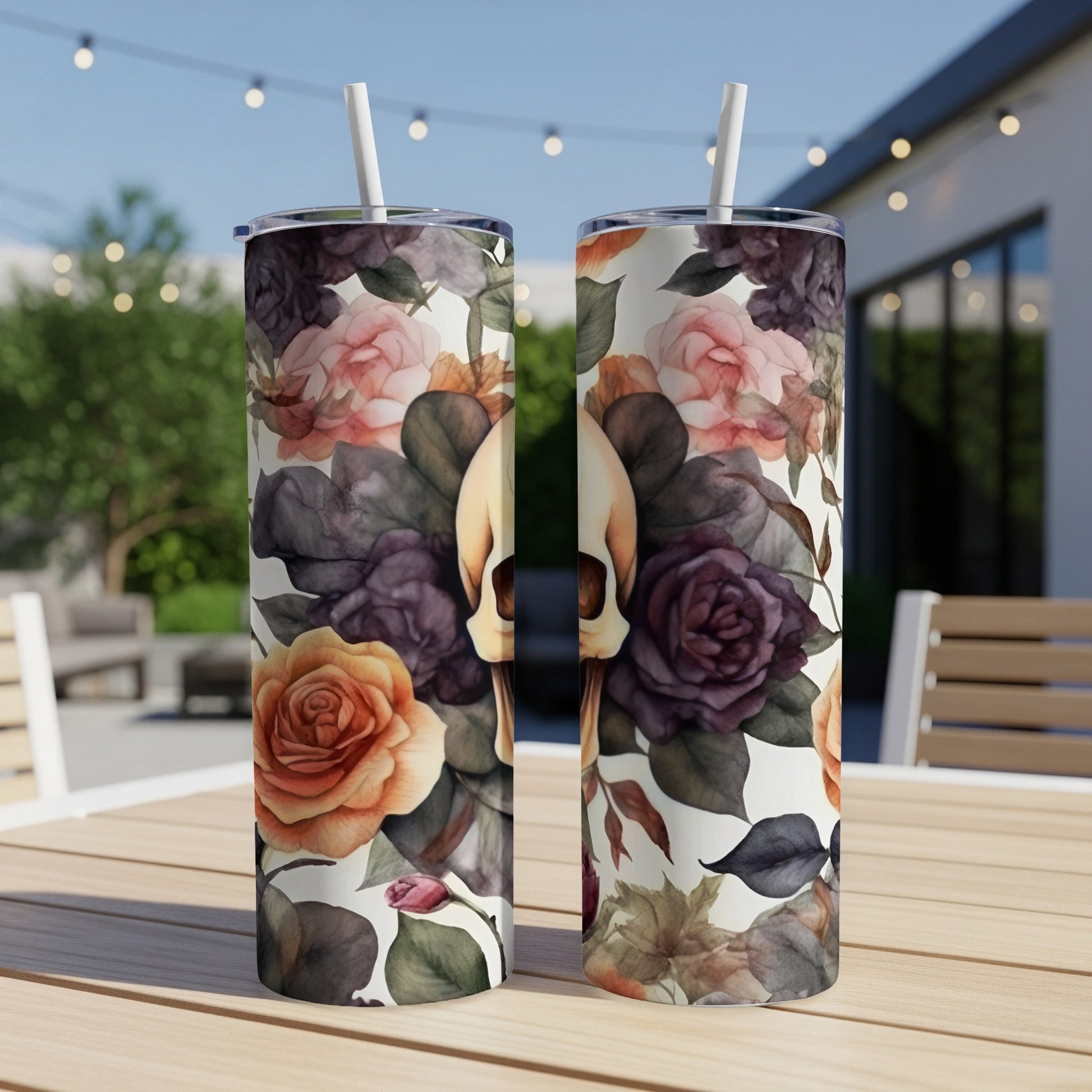 Two tumblers with a skull and floral pattern sit on a table.