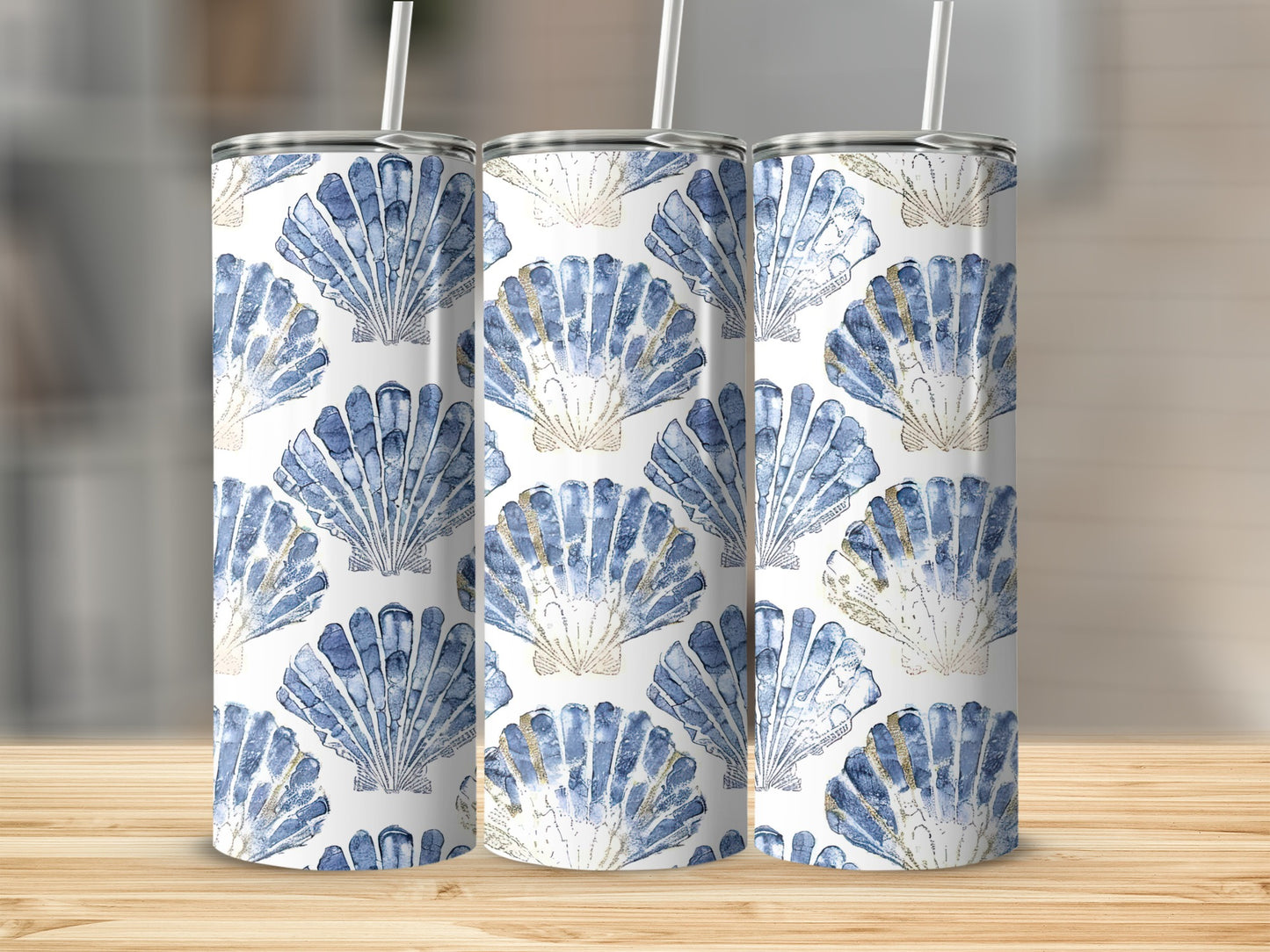 Three tumblers with a blue and gold seashell pattern.