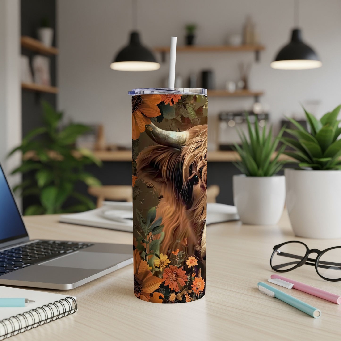 Highland cow with sunflowers and floral pattern on a tumbler.