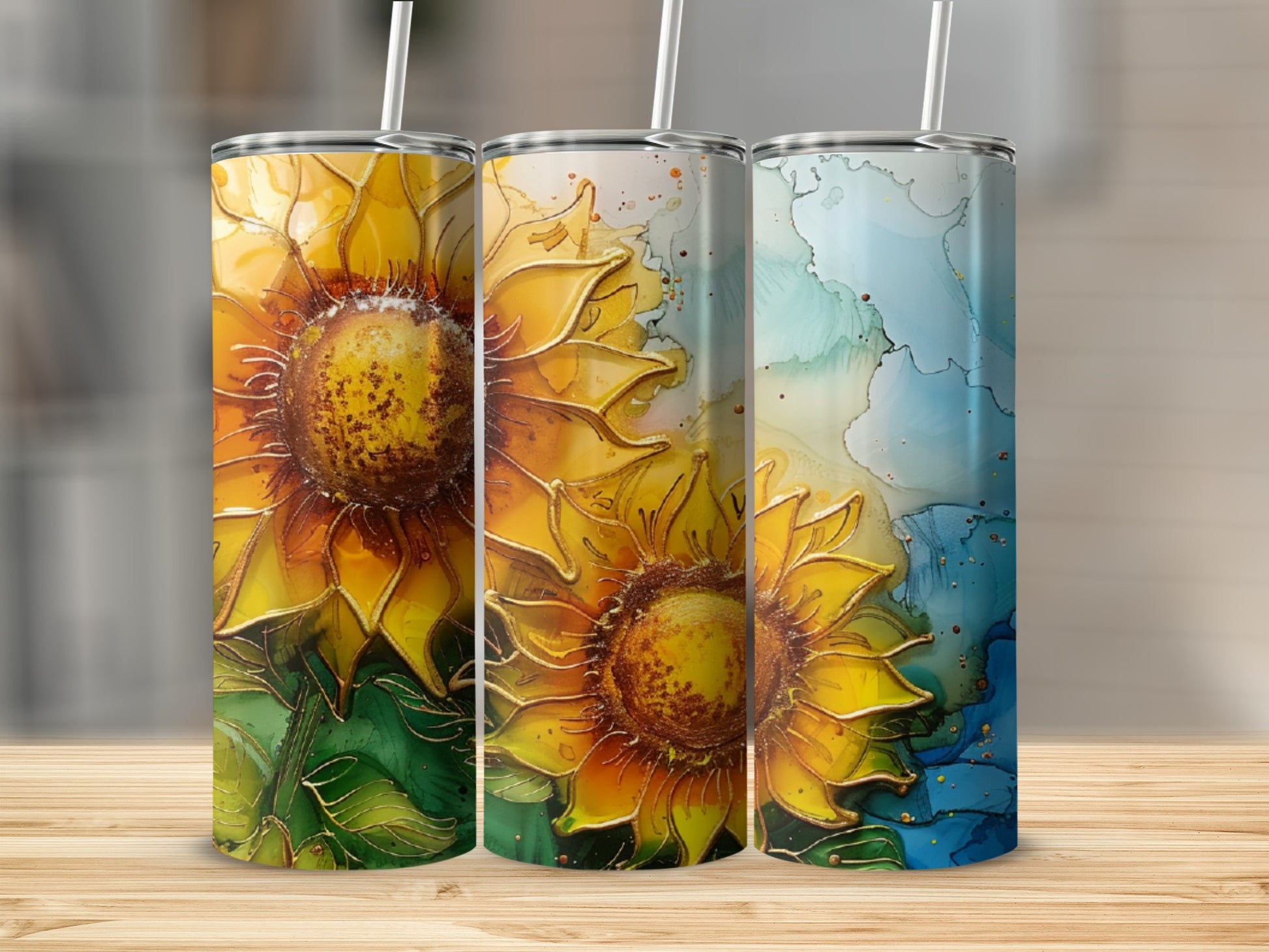 Three tumblers featuring sunflowers and abstract watercolor designs.
