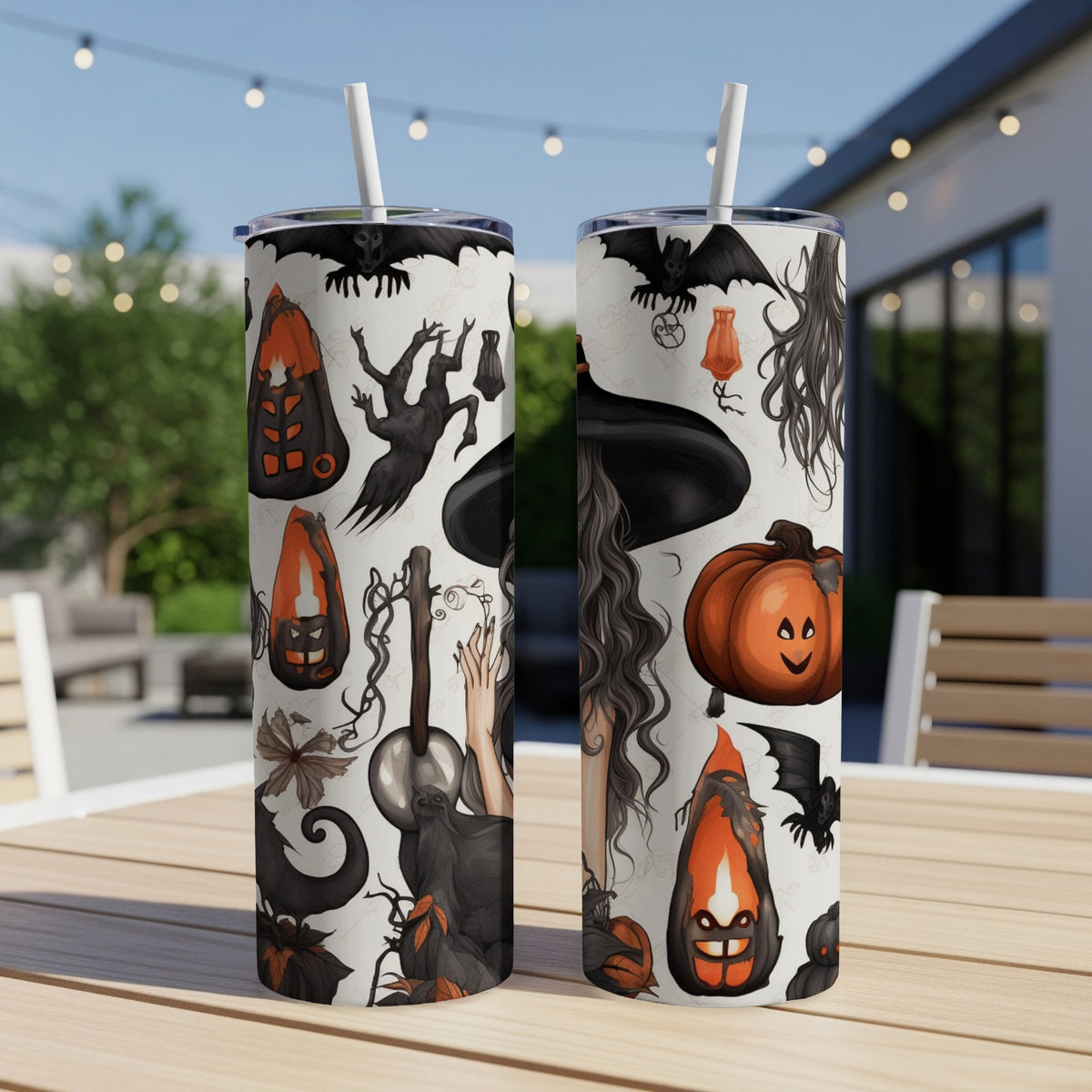 Two tumblers with Halloween illustrations of bats, witches, and pumpkins on a table.