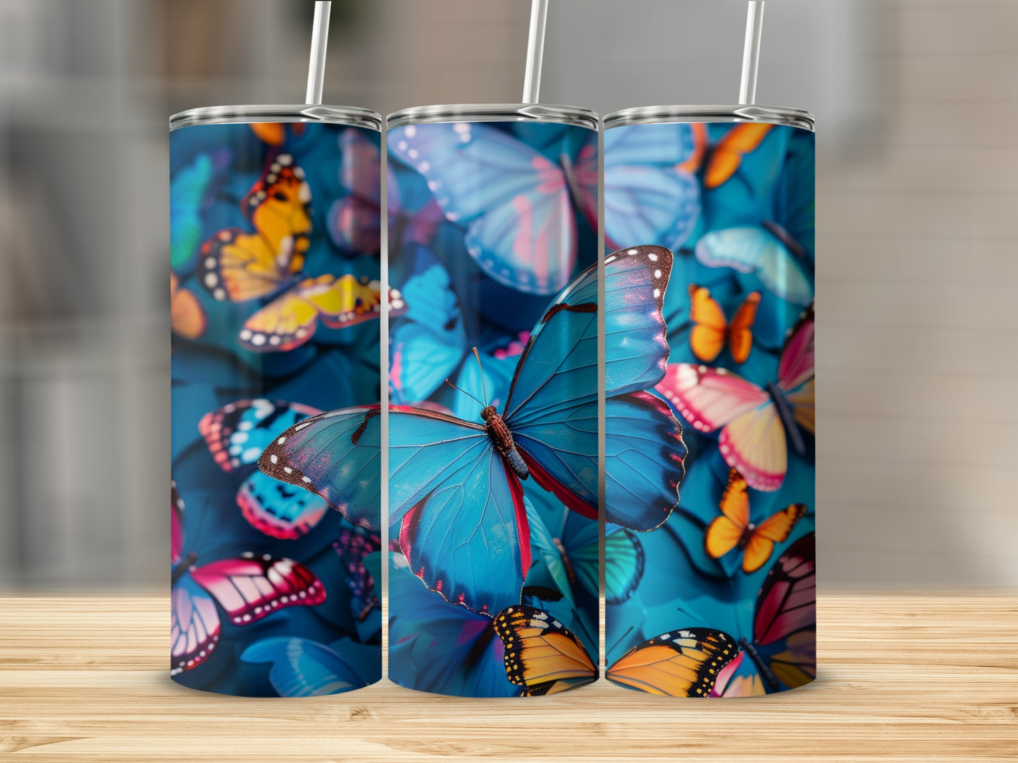 Three tumblers with blue butterflies and floral patterns.