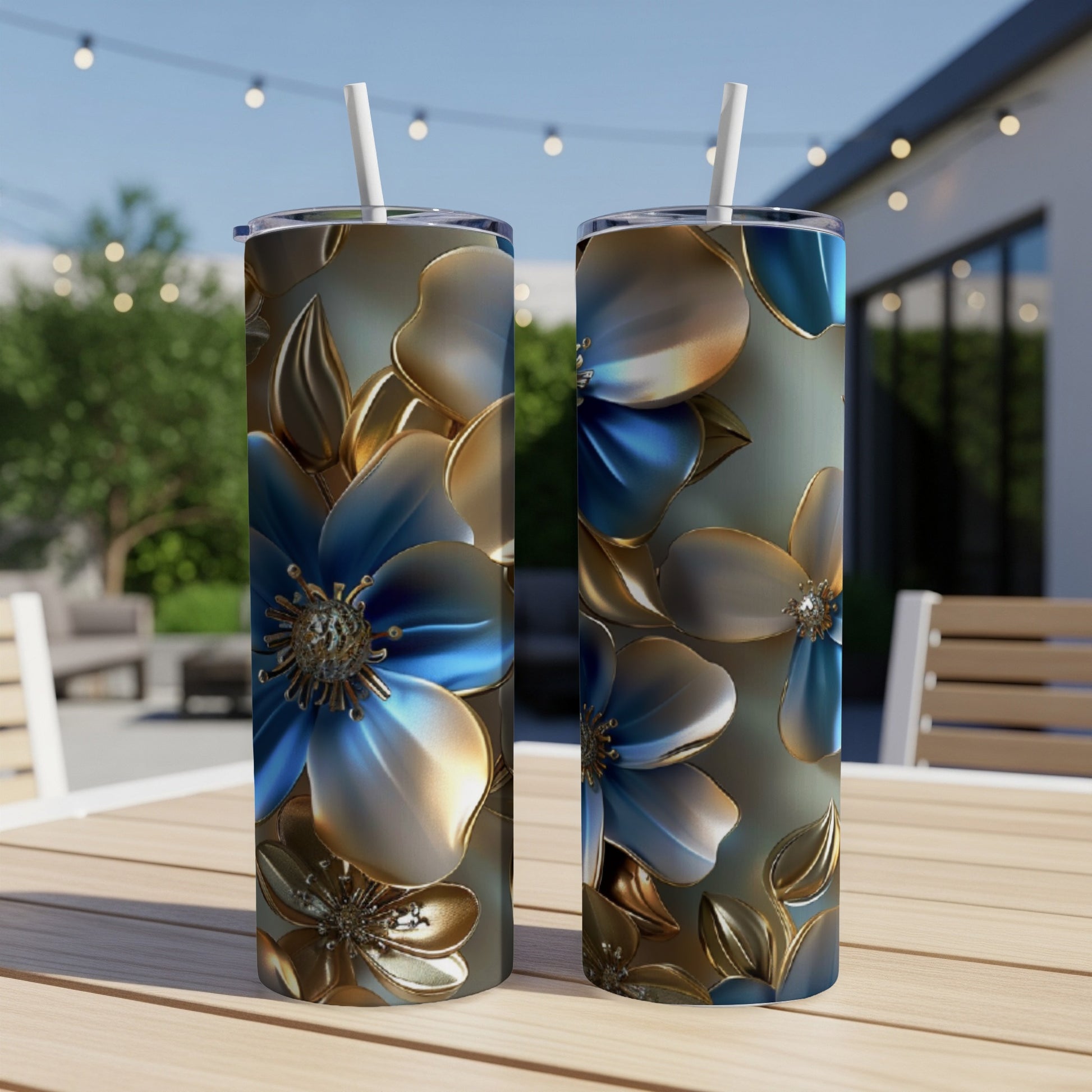 Two tumblers with blue and gold floral pattern on a table.
