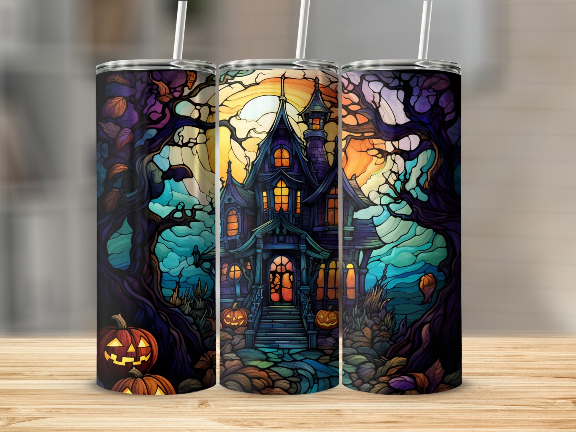 Spooky stained-glass haunted house and pumpkins on a tumbler.