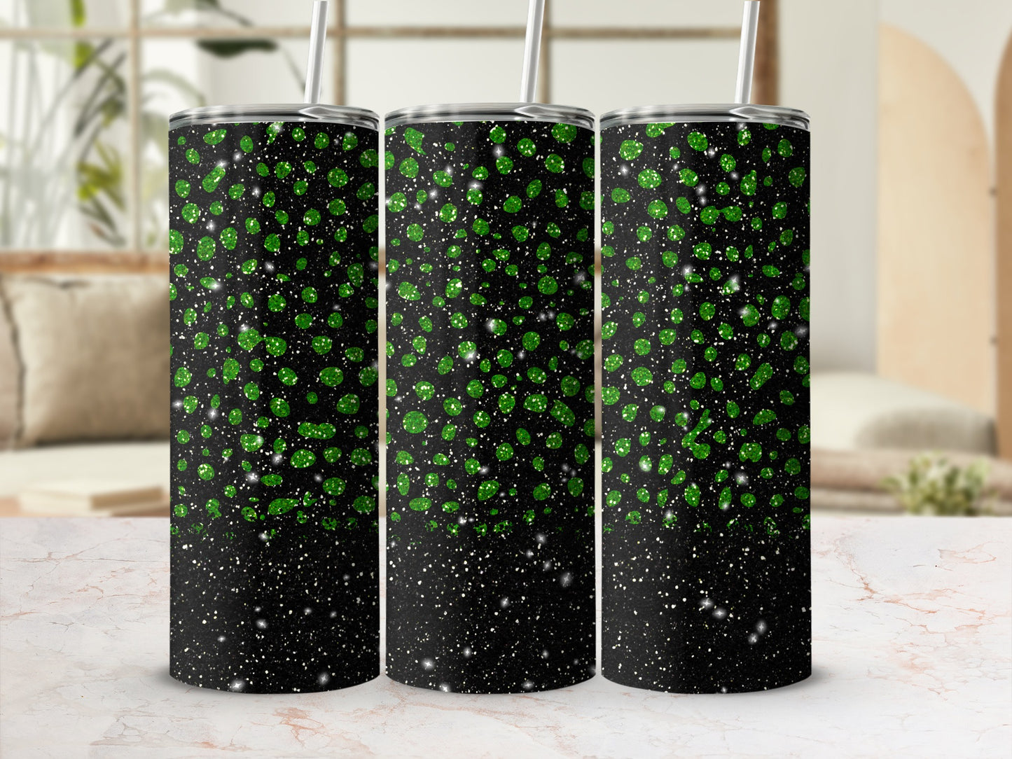 Three black tumblers with green glitter speckles and silver straws.