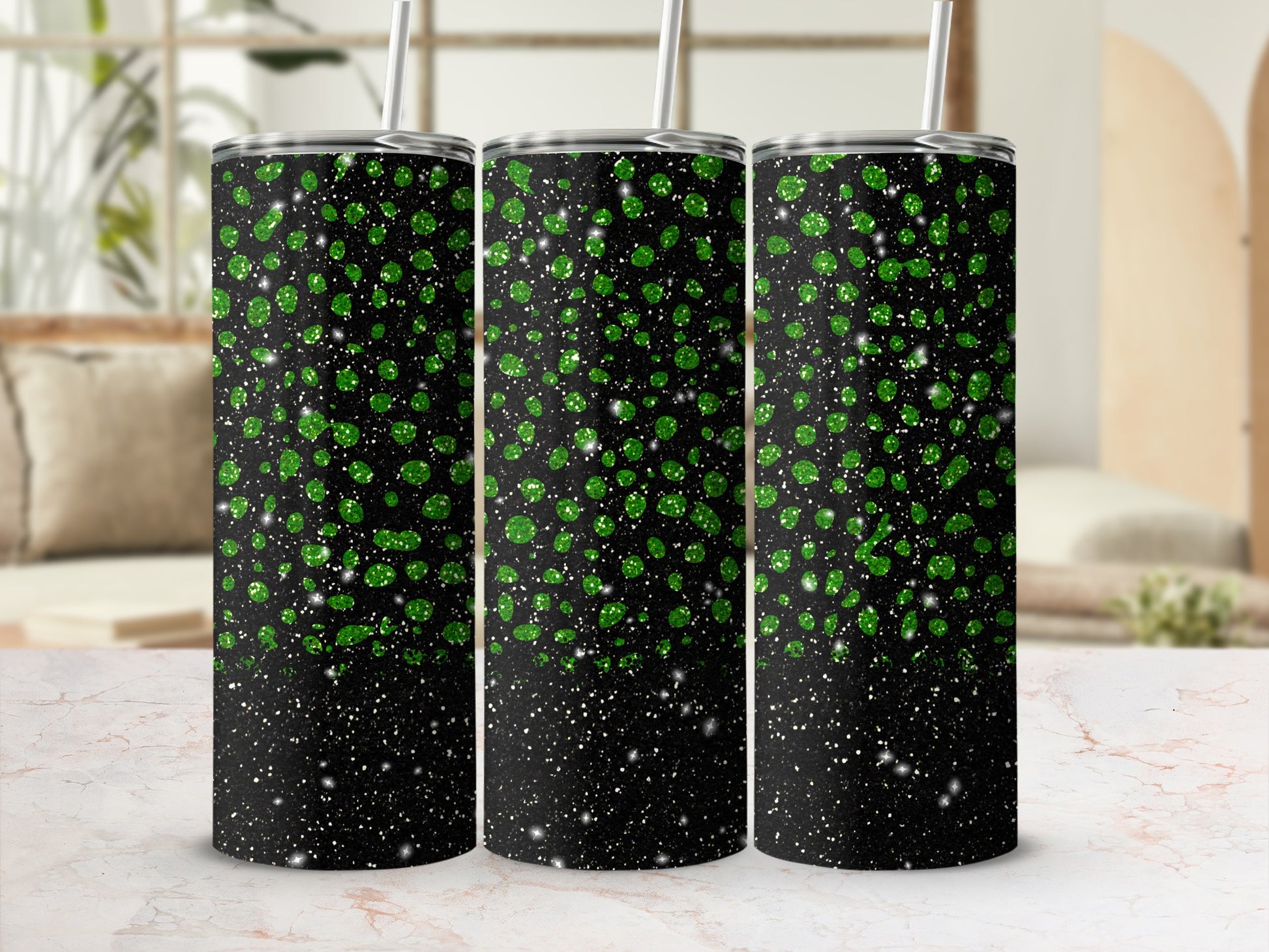 Three black tumblers with green glitter speckles and silver straws.