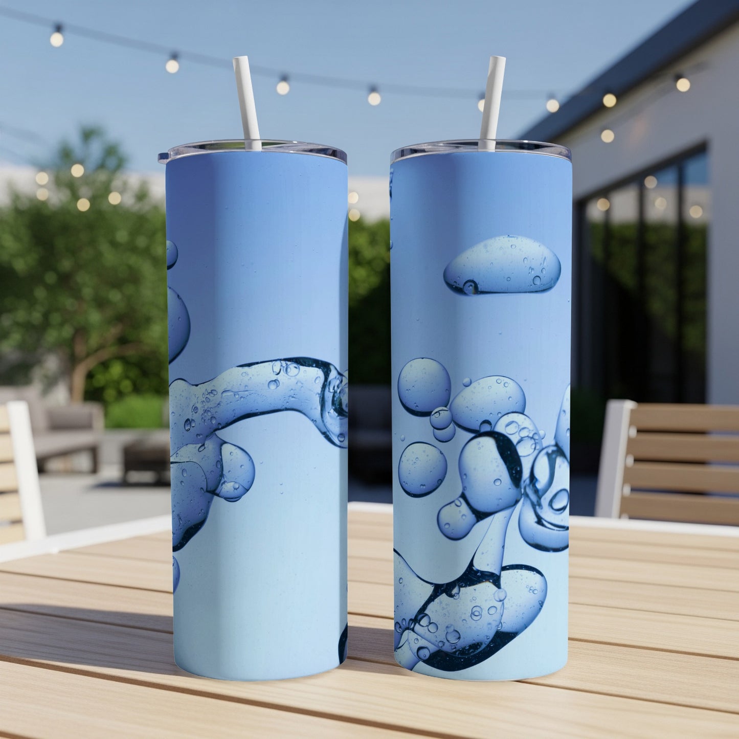 Two tall blue tumblers with abstract blue bubble and liquid patterns.