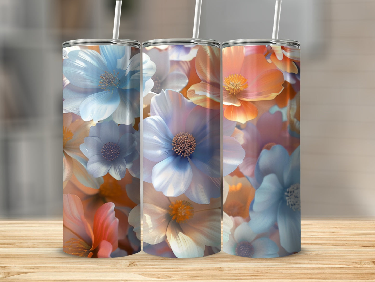 Three tumblers with floral designs in blue, peach, and white.