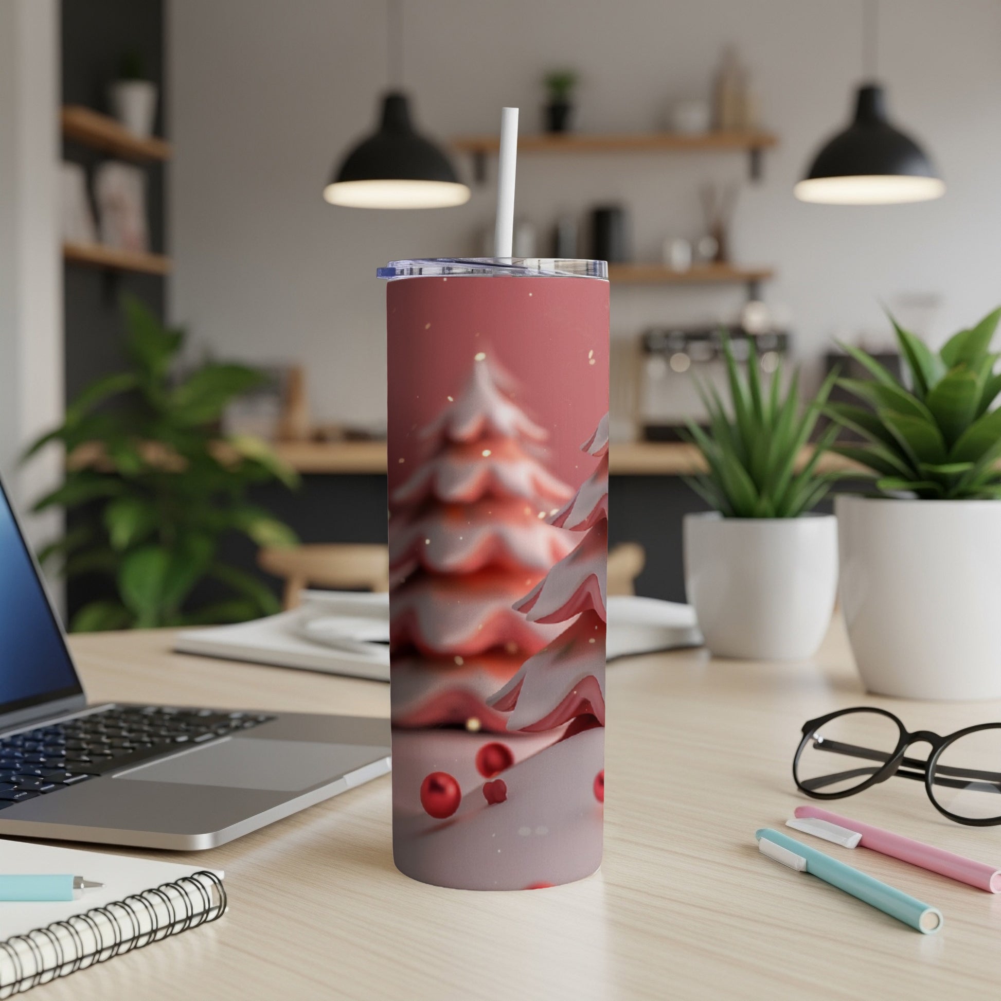 Pink tumbler with abstract snow-covered trees and red ornaments.