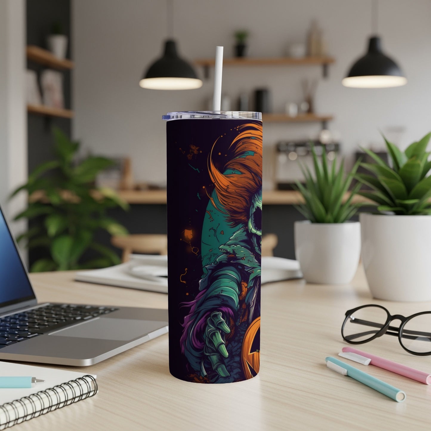 Tall tumbler with a spooky clown and pumpkin Halloween design, featuring a straw.