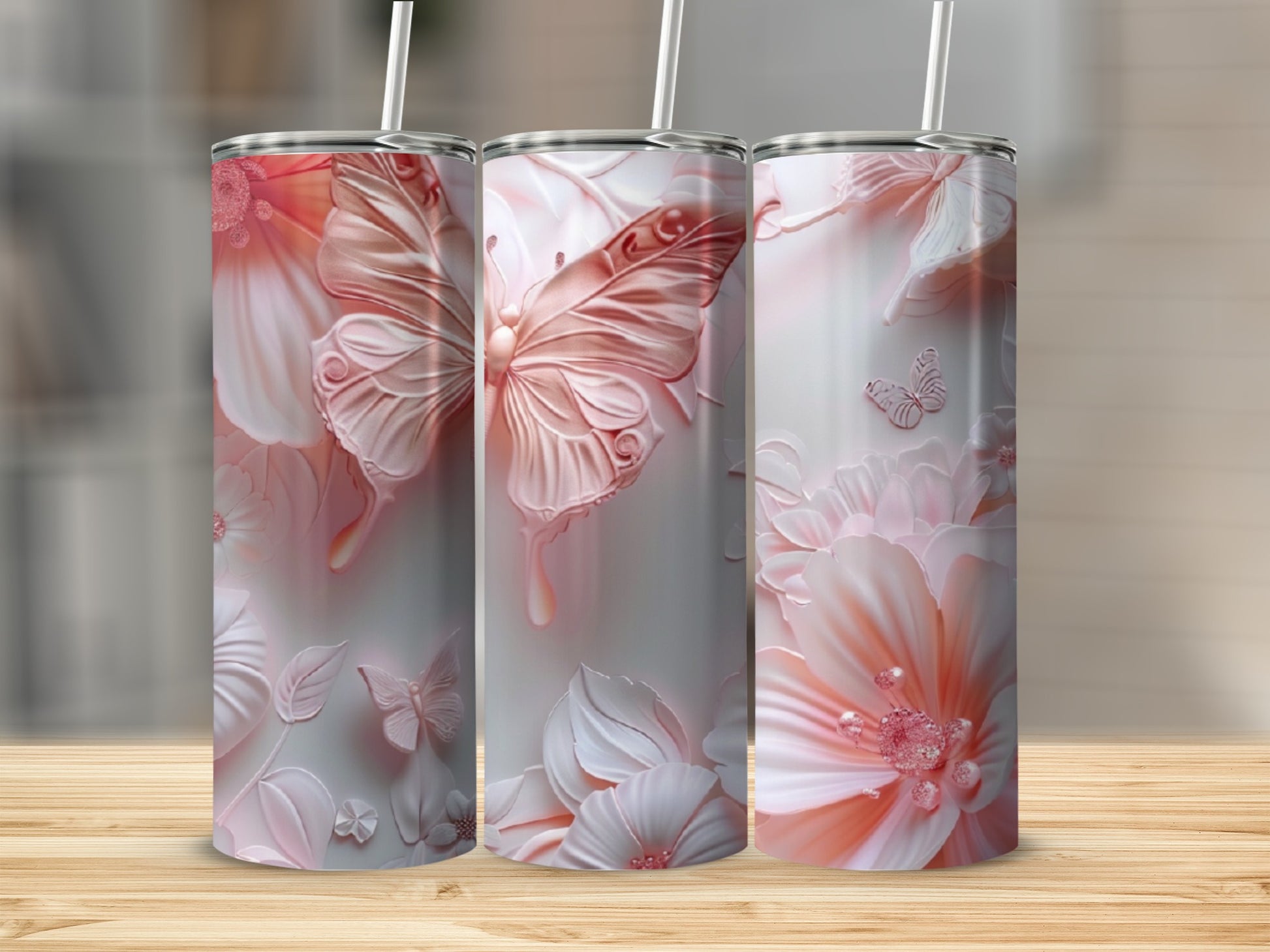 Three tumblers with a pink butterfly and floral design.