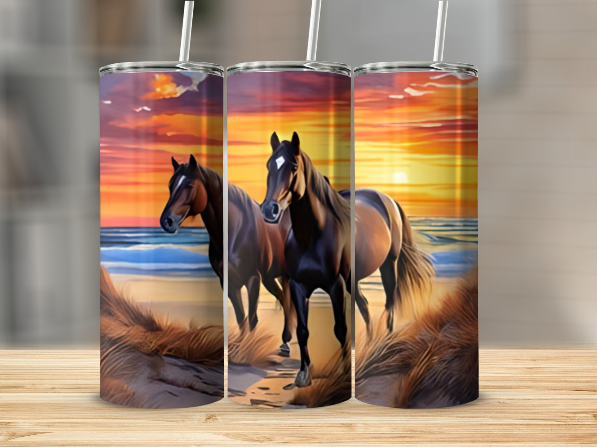 Two horses on a beach at sunset, depicted on three tumblers.
