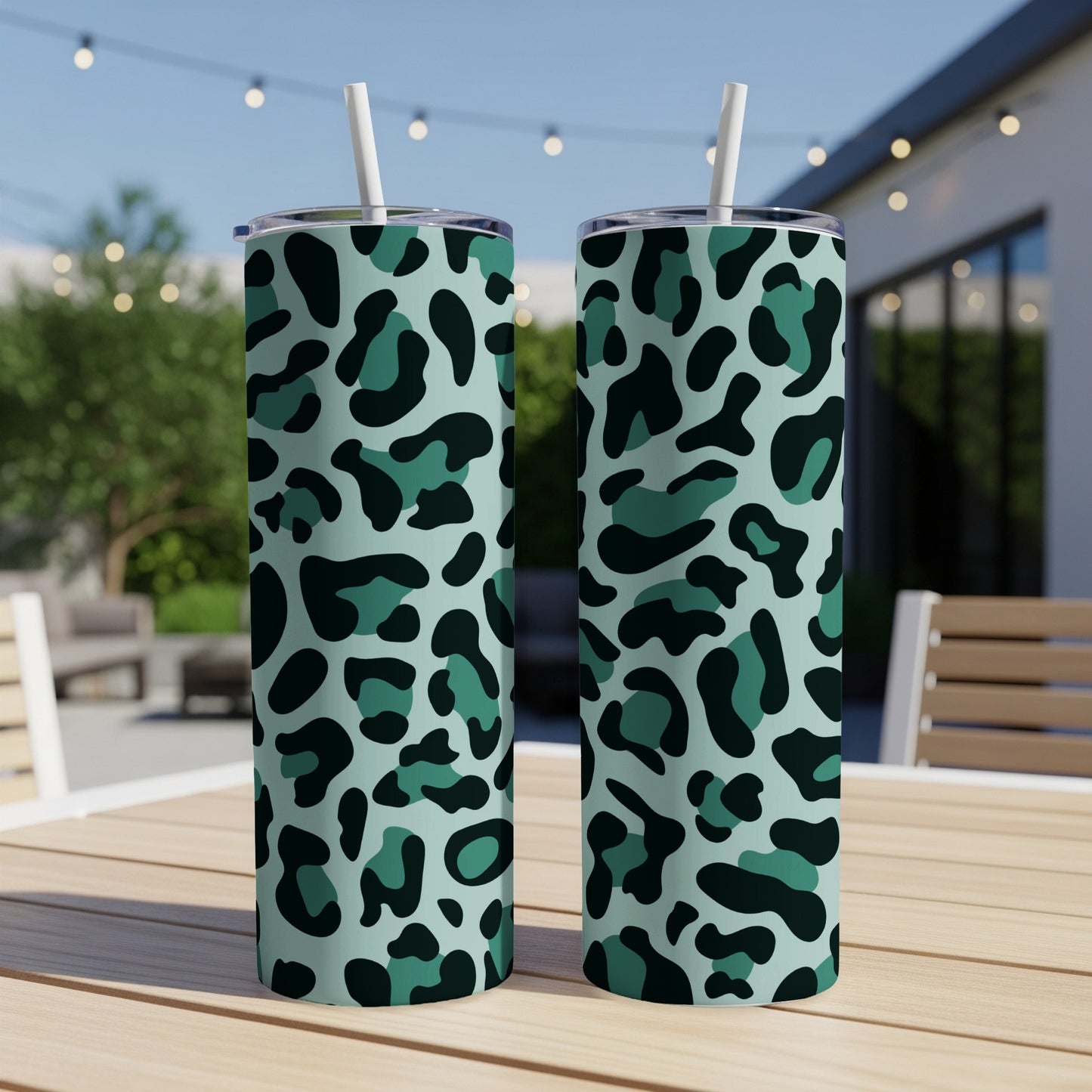 Two tumblers with a teal and dark green camouflage leopard print pattern.
