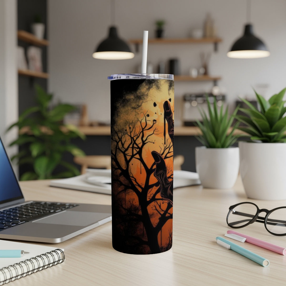 Tall tumbler with spooky black tree and hand design on orange background.