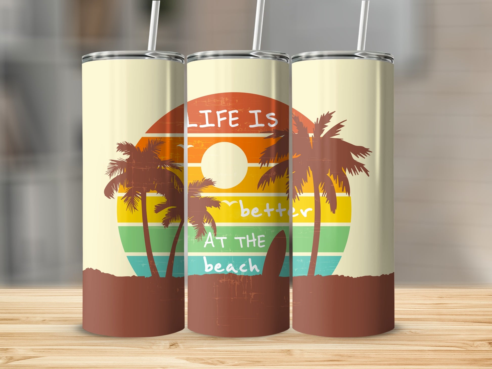 Sunset beach scene with palm trees and surfboard graphic on tumblers.