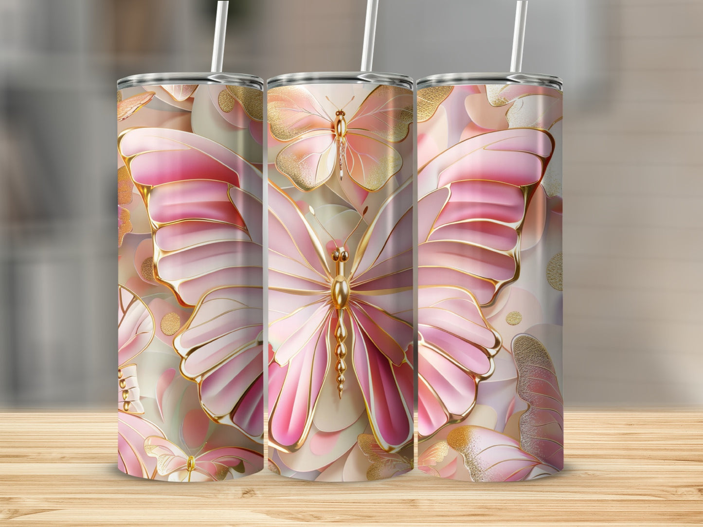 Pink butterfly tumbler with gold accents on wooden surface.
