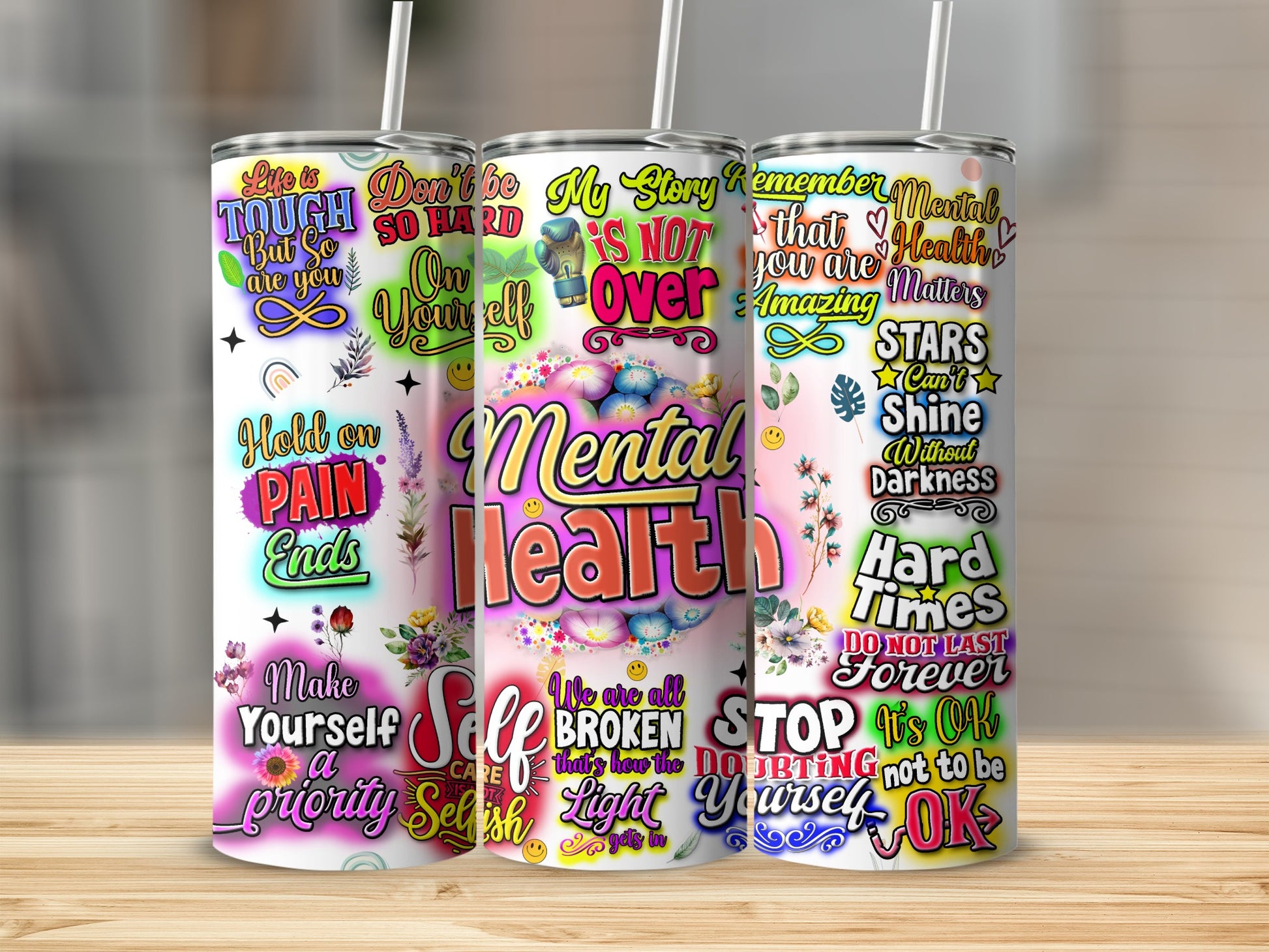 Floral mental health tumbler with inspirational quotes in rainbow colors.