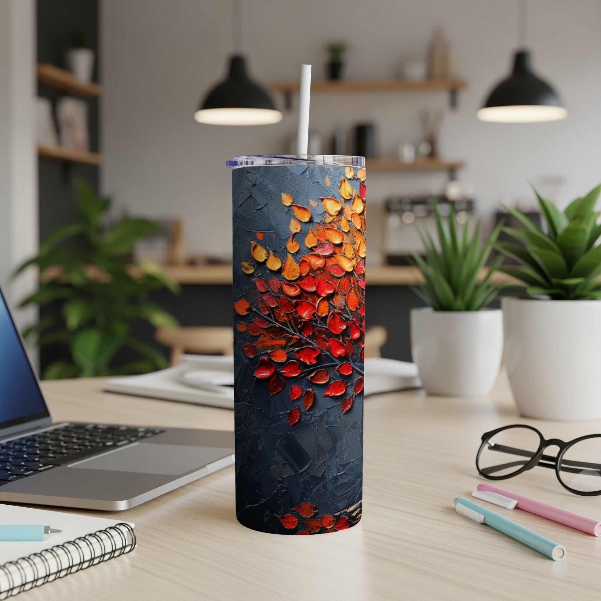 Dark tumbler with textured abstract red and orange leaves pattern.