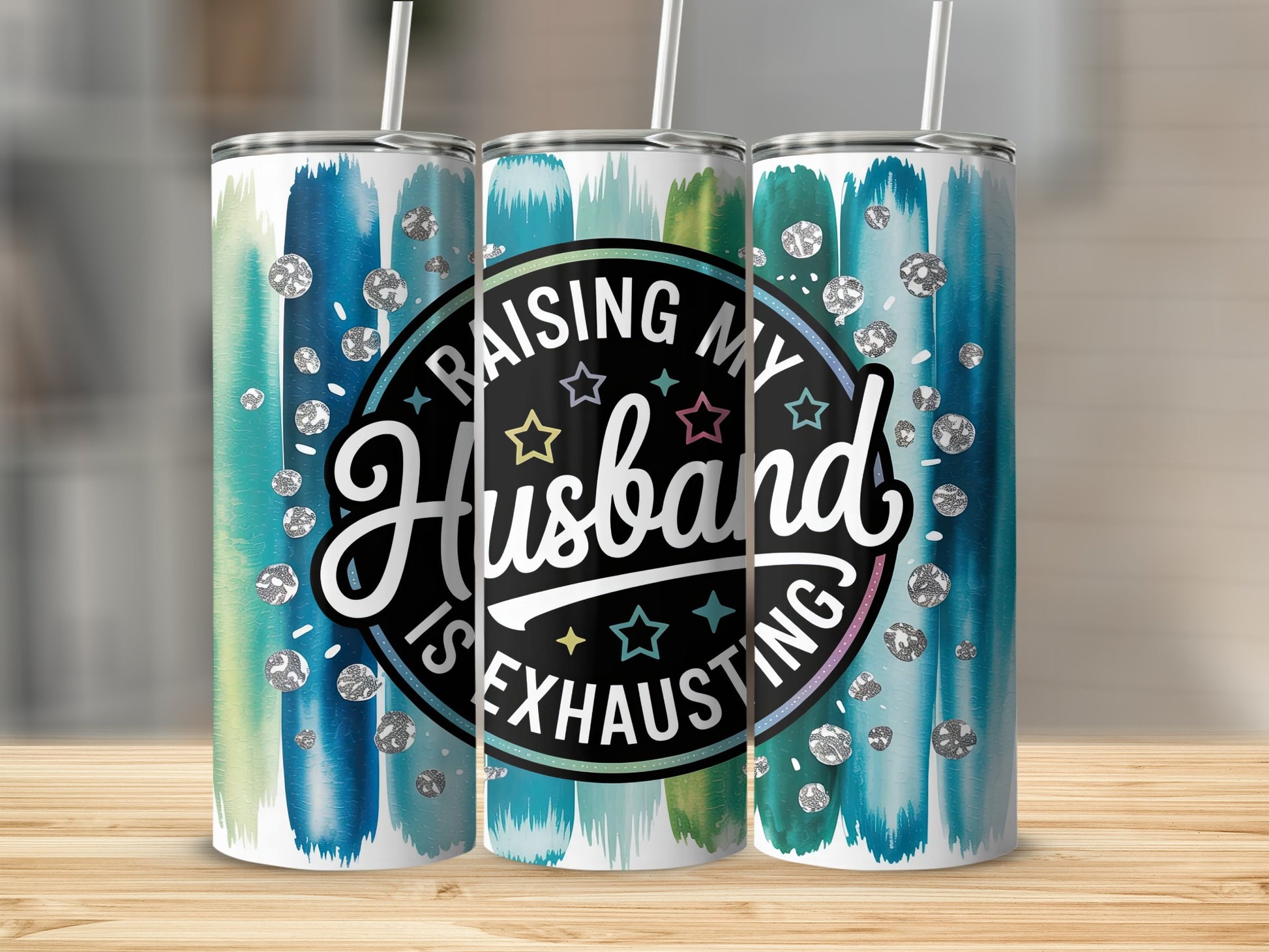 Tumbler with "Raising my Husband is exhausting" text and colorful brush strokes.
