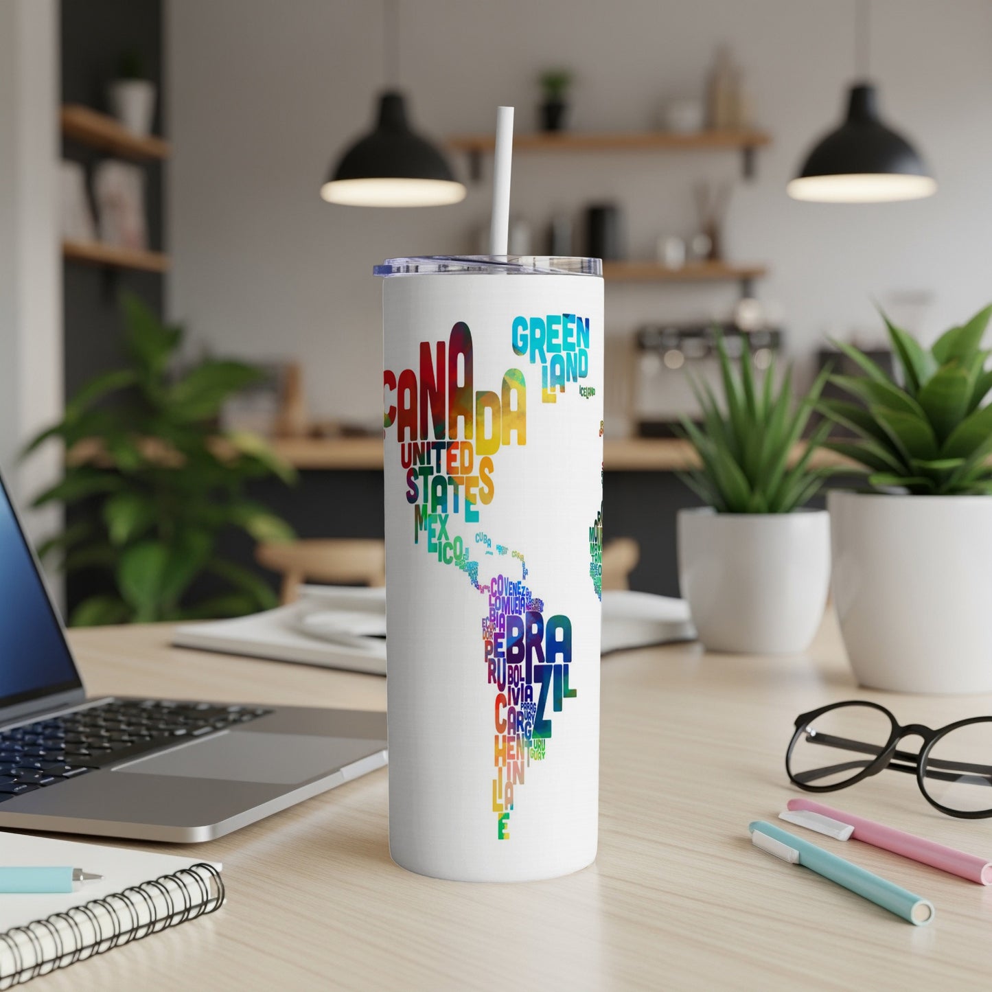 White tumbler with colorful map of North and South America made of country names.