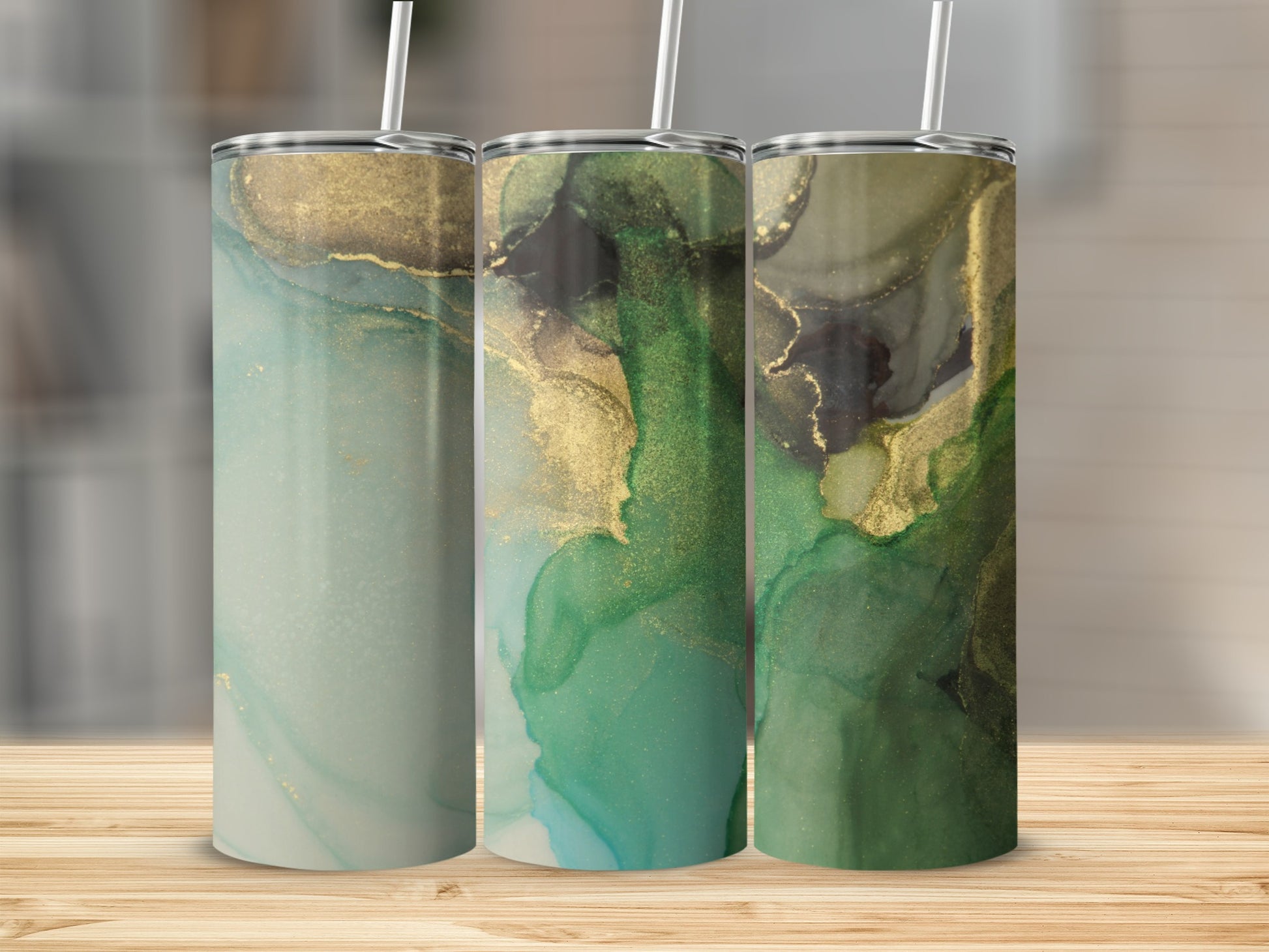 Three tumblers with abstract green and gold marbled designs.