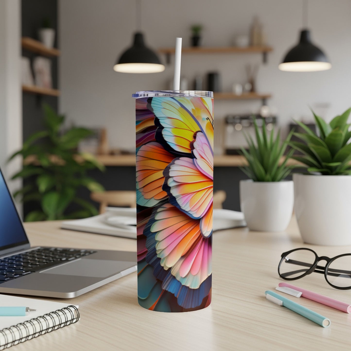 Colorful butterfly art on a white skinny tumbler with a straw.