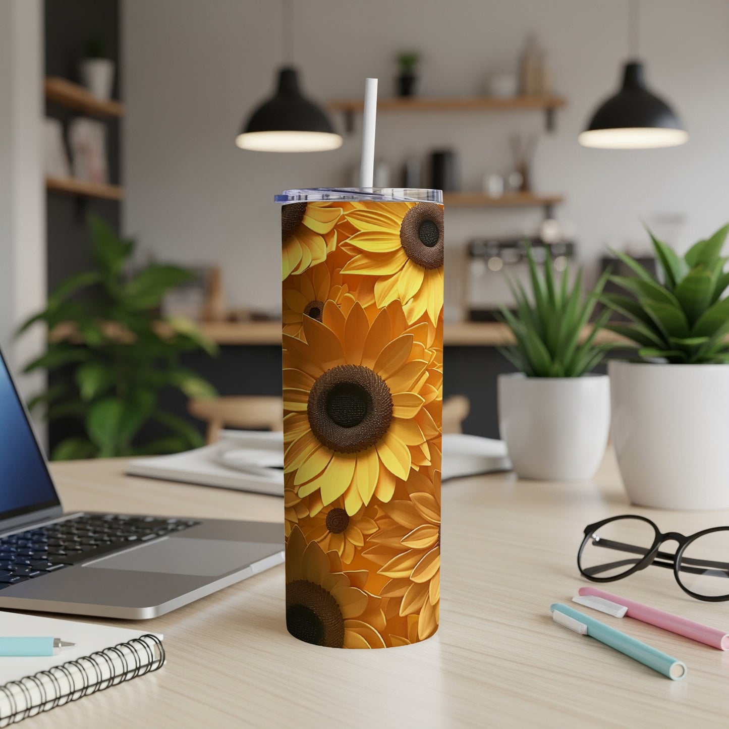 Tall tumbler with a repeating sunflower pattern and a straw.