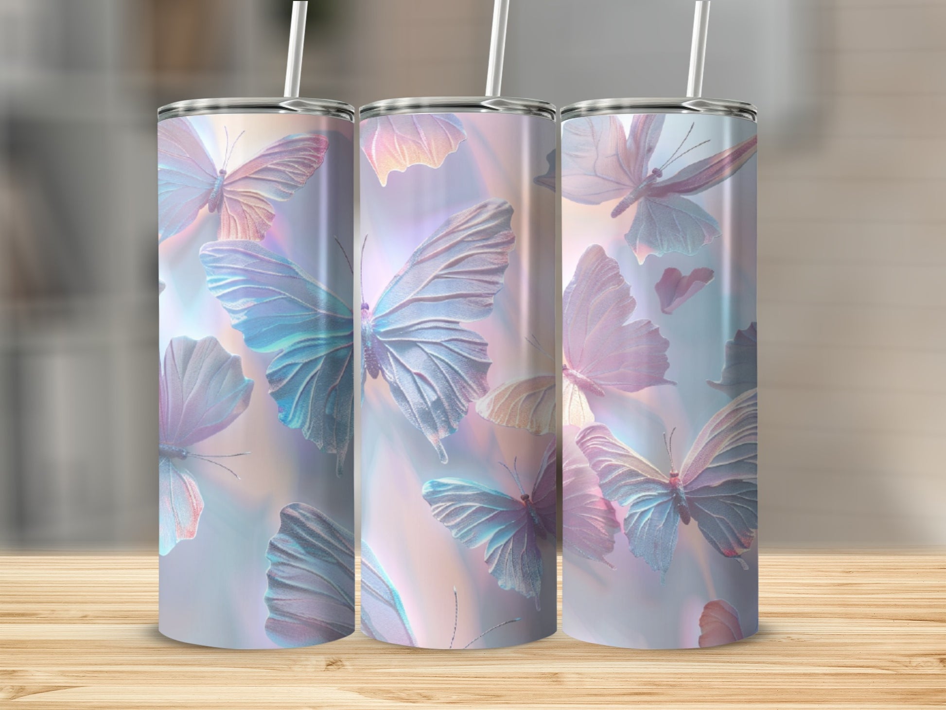 Three iridescent tumblers with butterfly designs on a wooden surface.