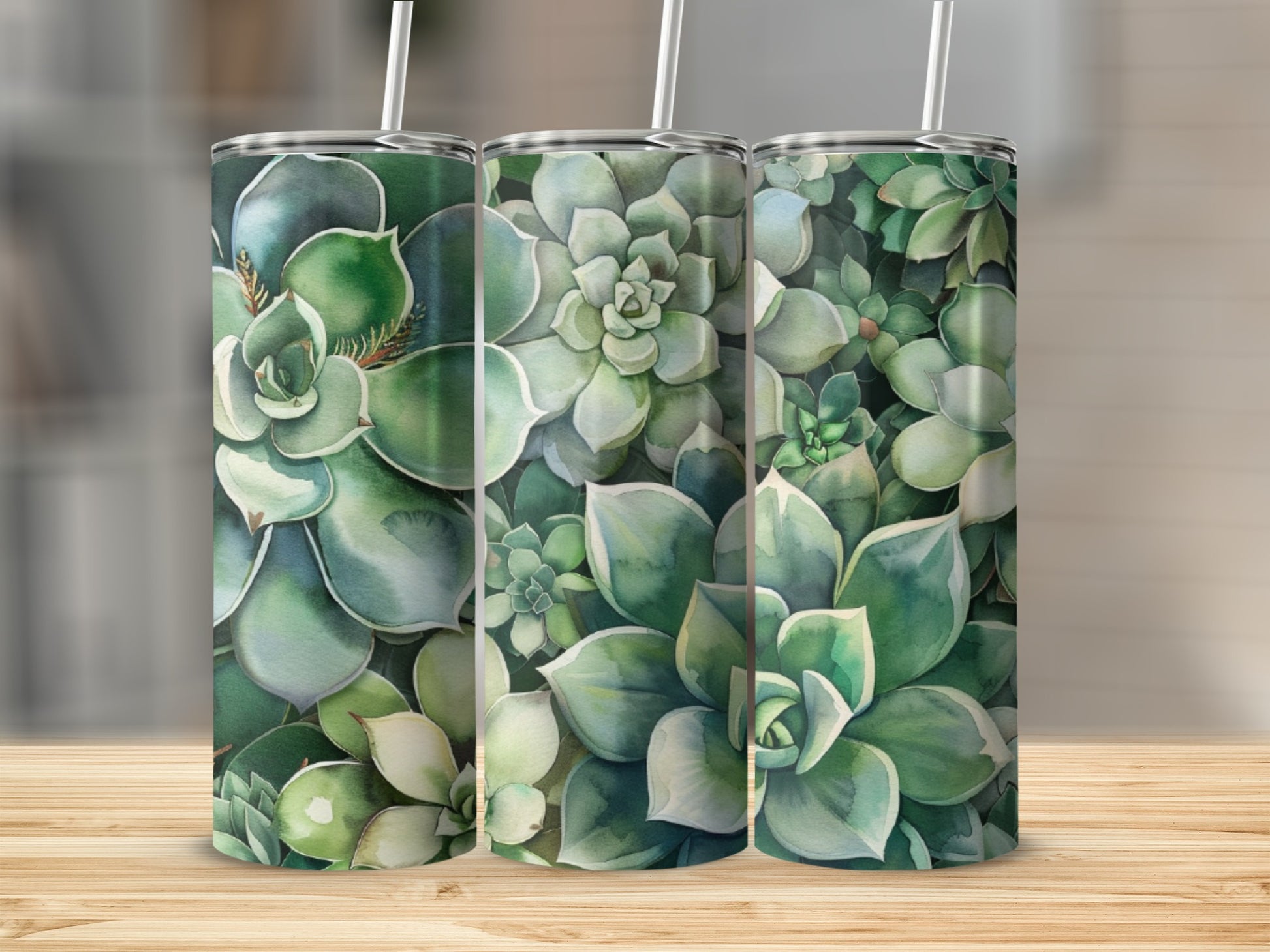 Three tumblers with a succulent plant pattern on a wooden surface.