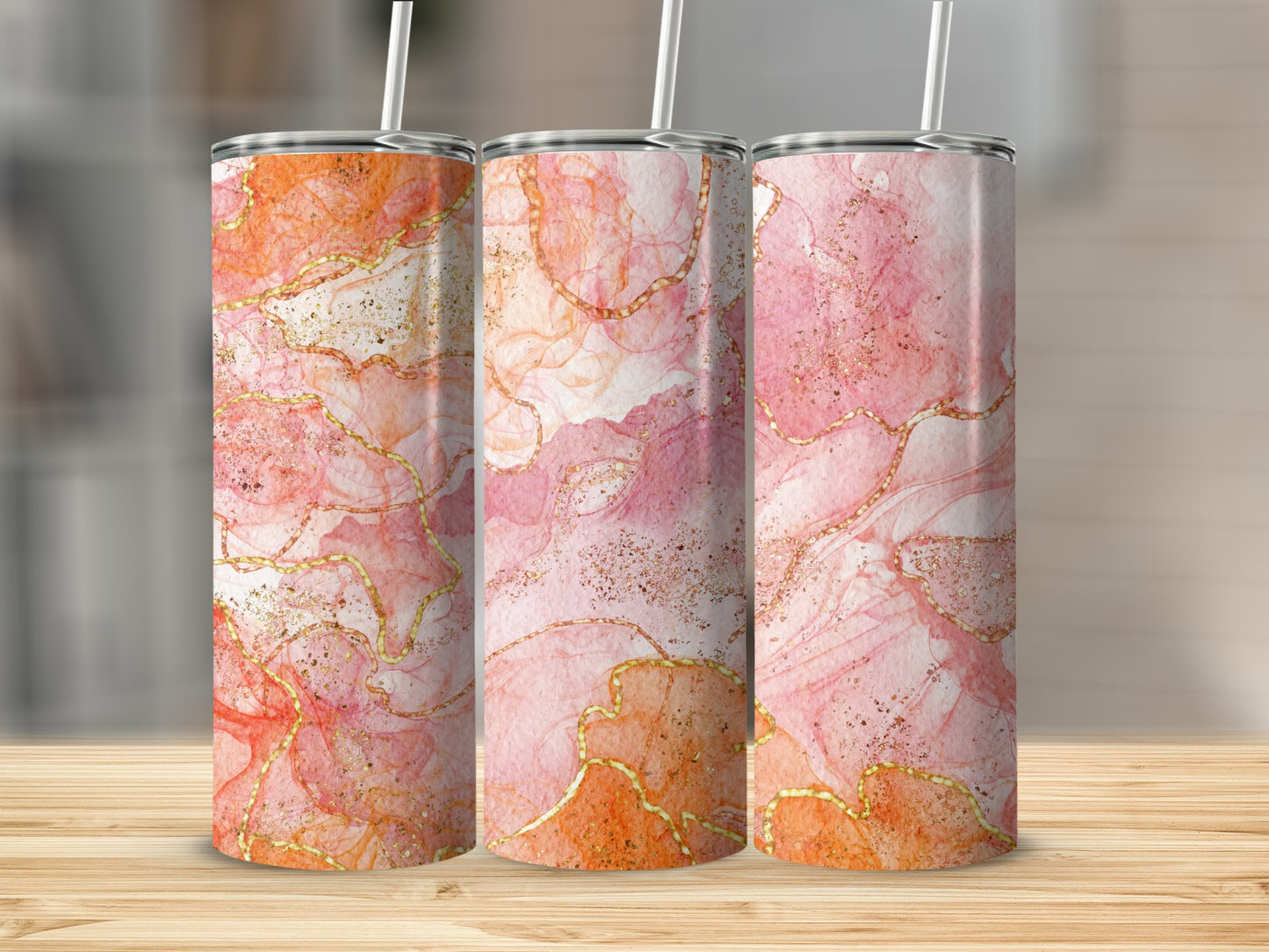 Three tumblers with pink and orange marbled design and gold accents.