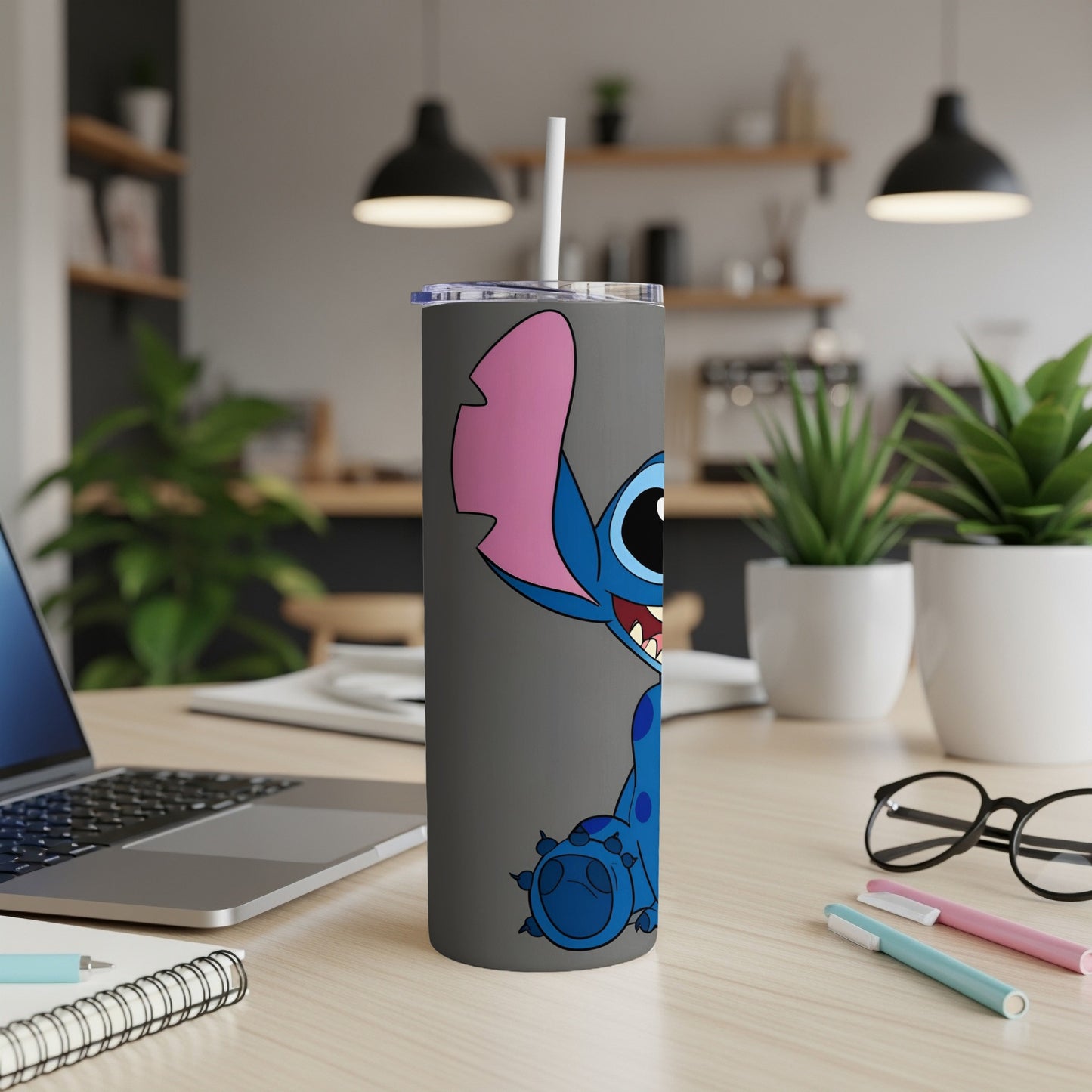 Stitch character design on a grey tumbler with a white straw.
