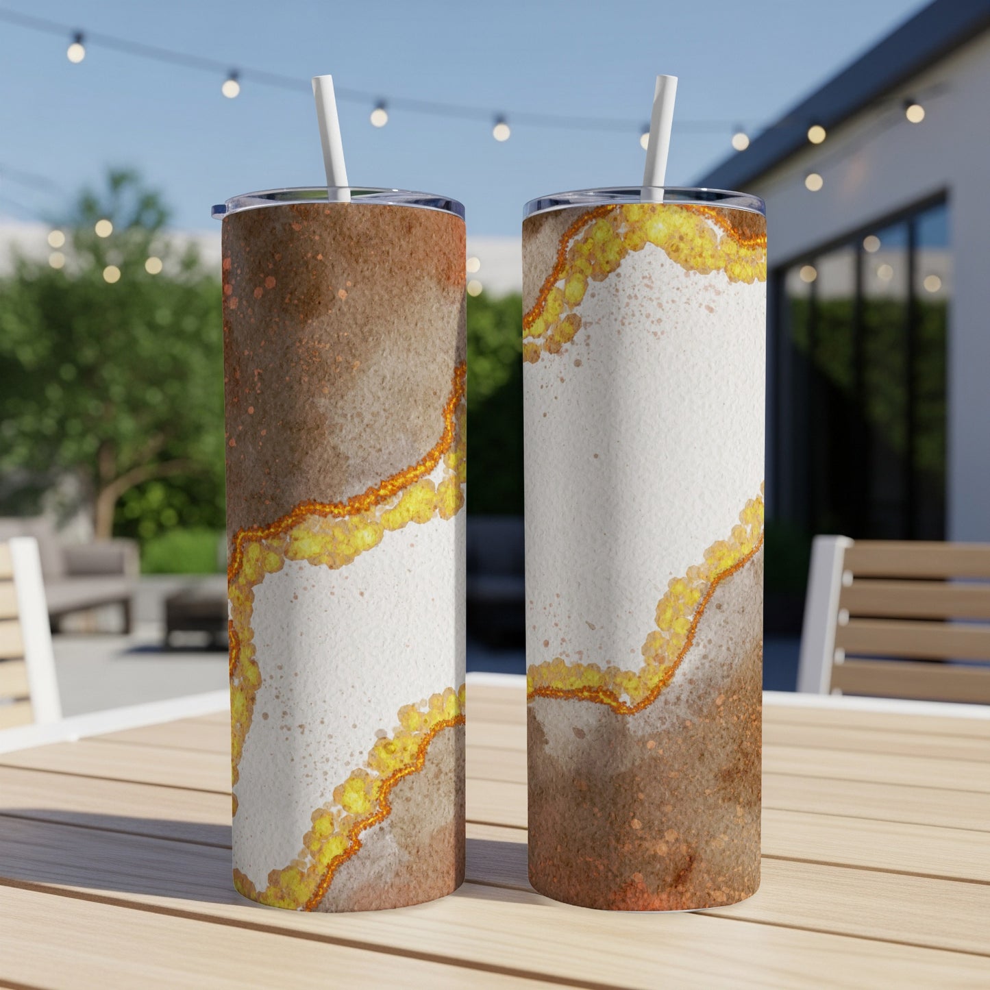 Two tall tumblers with marbled brown and white patterns and gold accents.