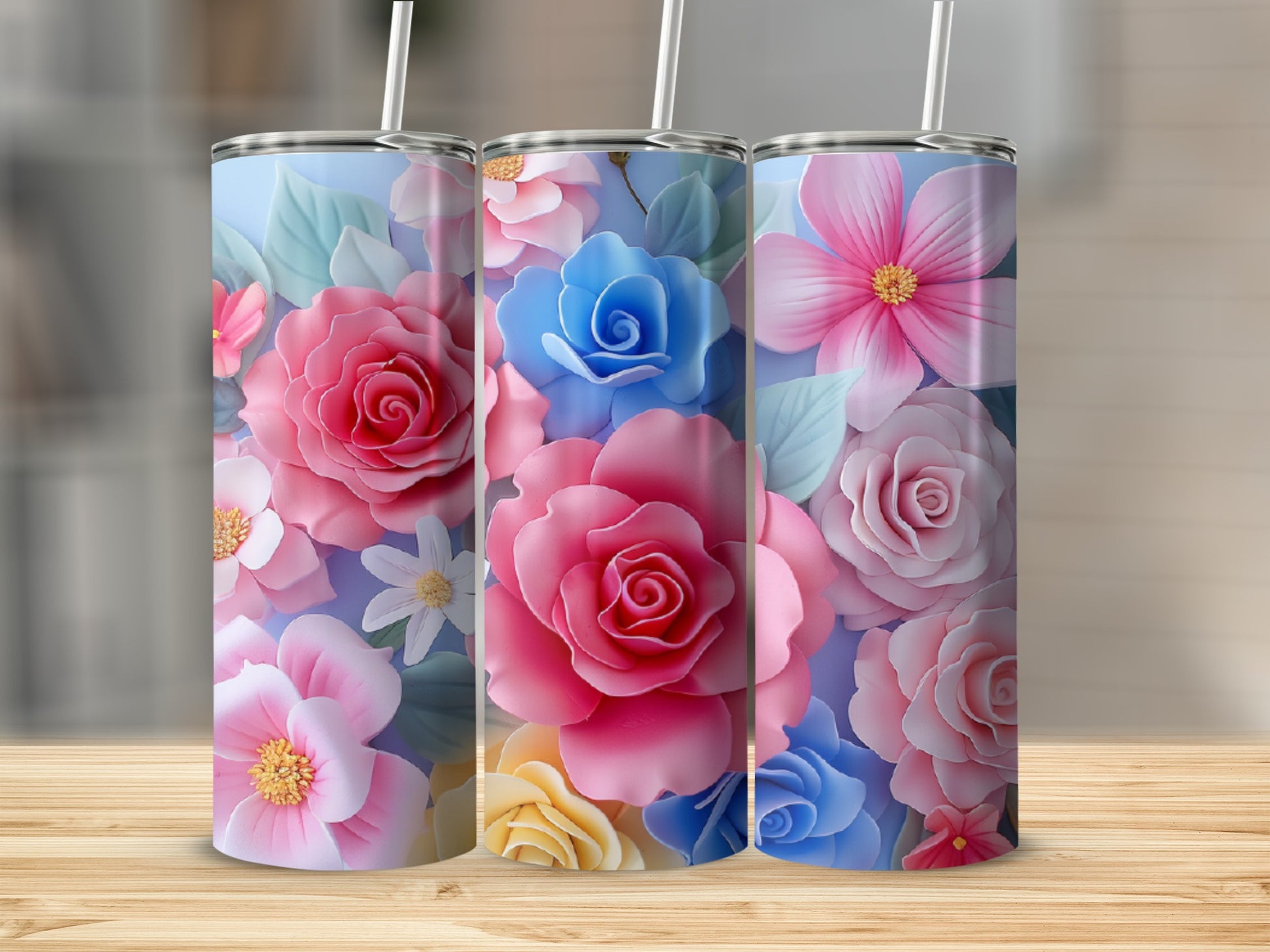Three tumblers with colorful floral designs.