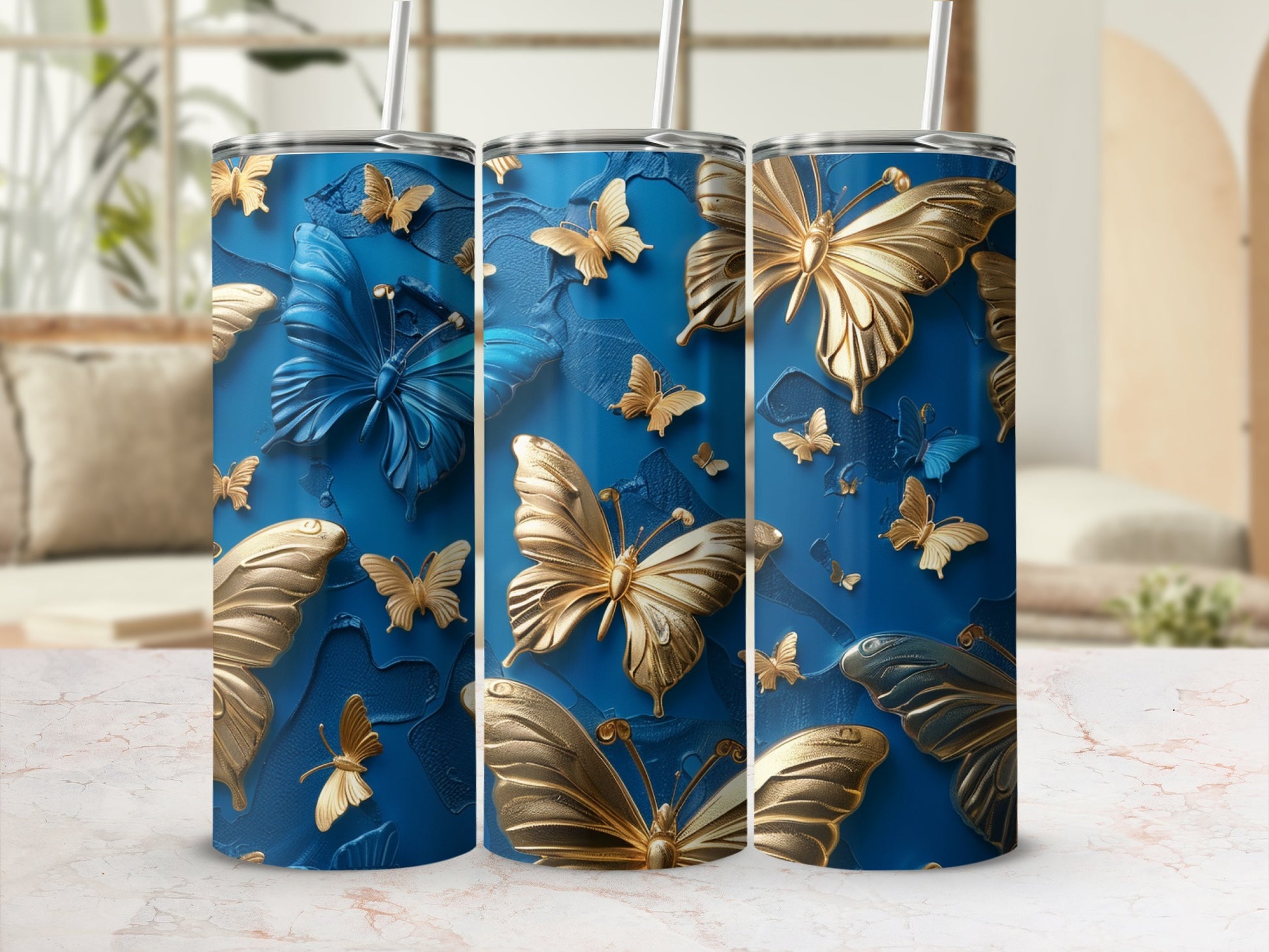 Three blue tumblers with raised gold and blue butterflies.