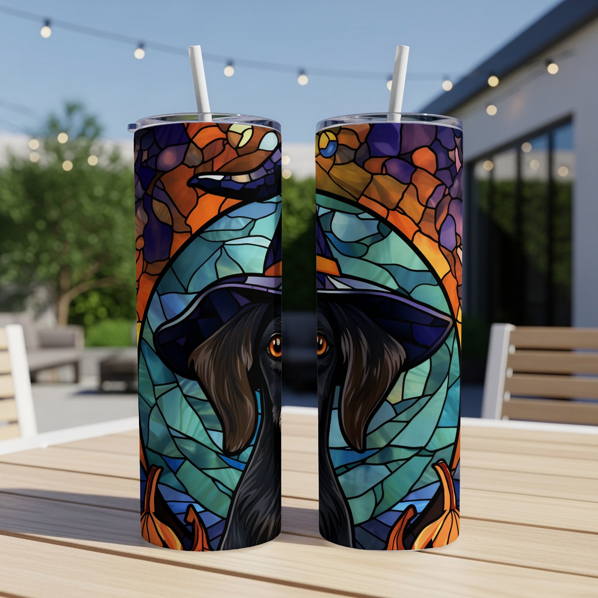 Black dog wearing a witch hat, stained glass style, on a tumbler.