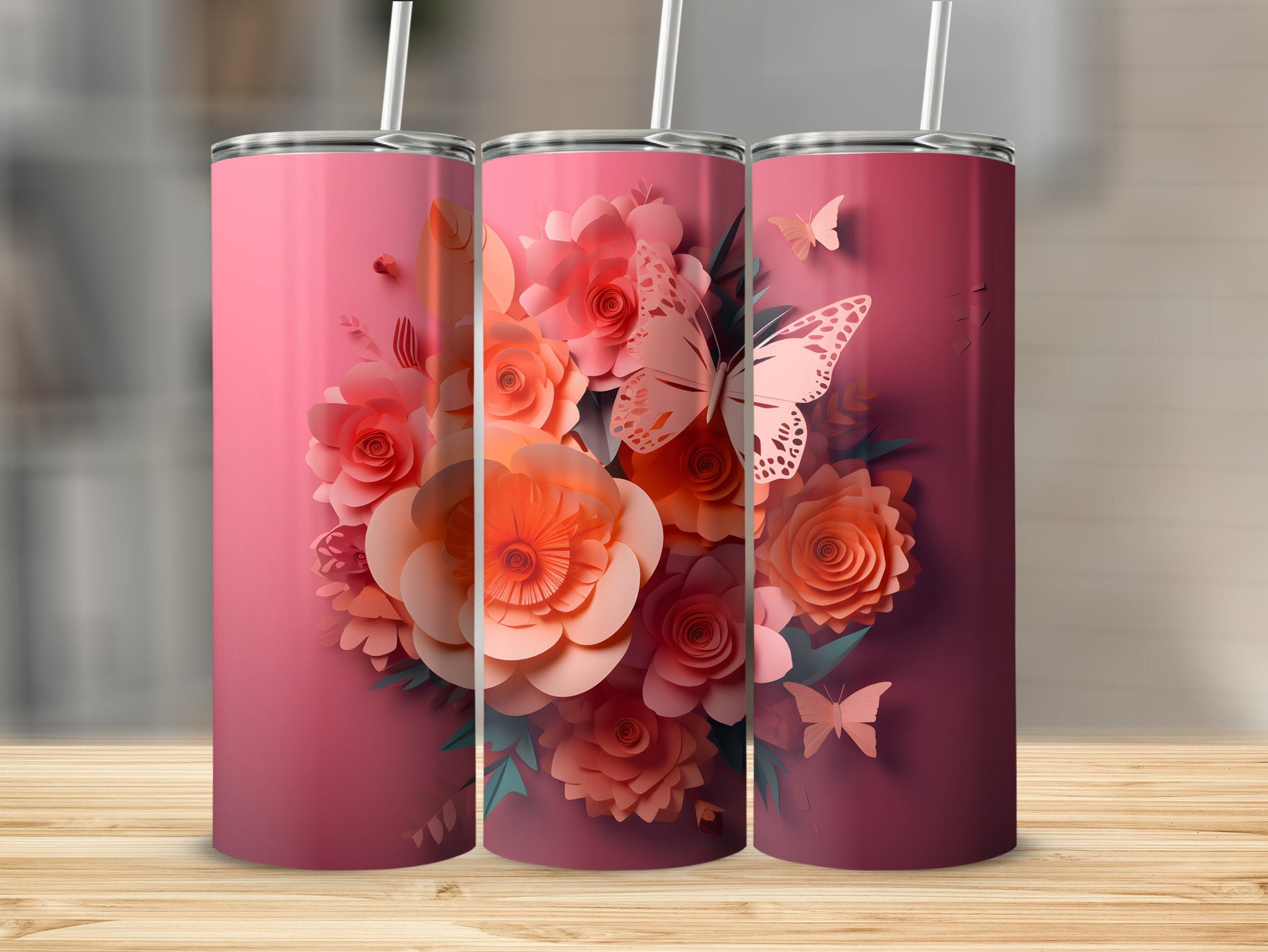 Three pink tumblers with floral and butterfly designs.