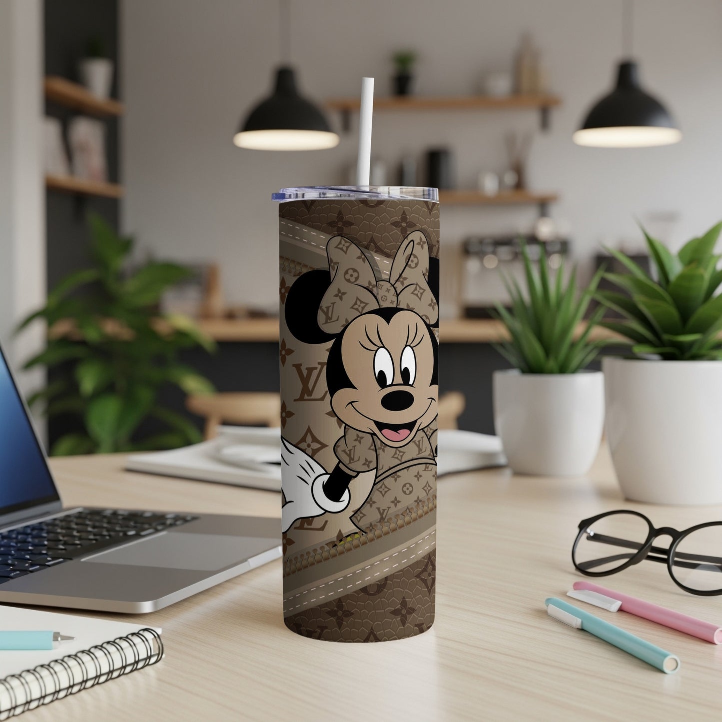 Minnie Mouse on a brown tumbler with a monogram pattern and straw.