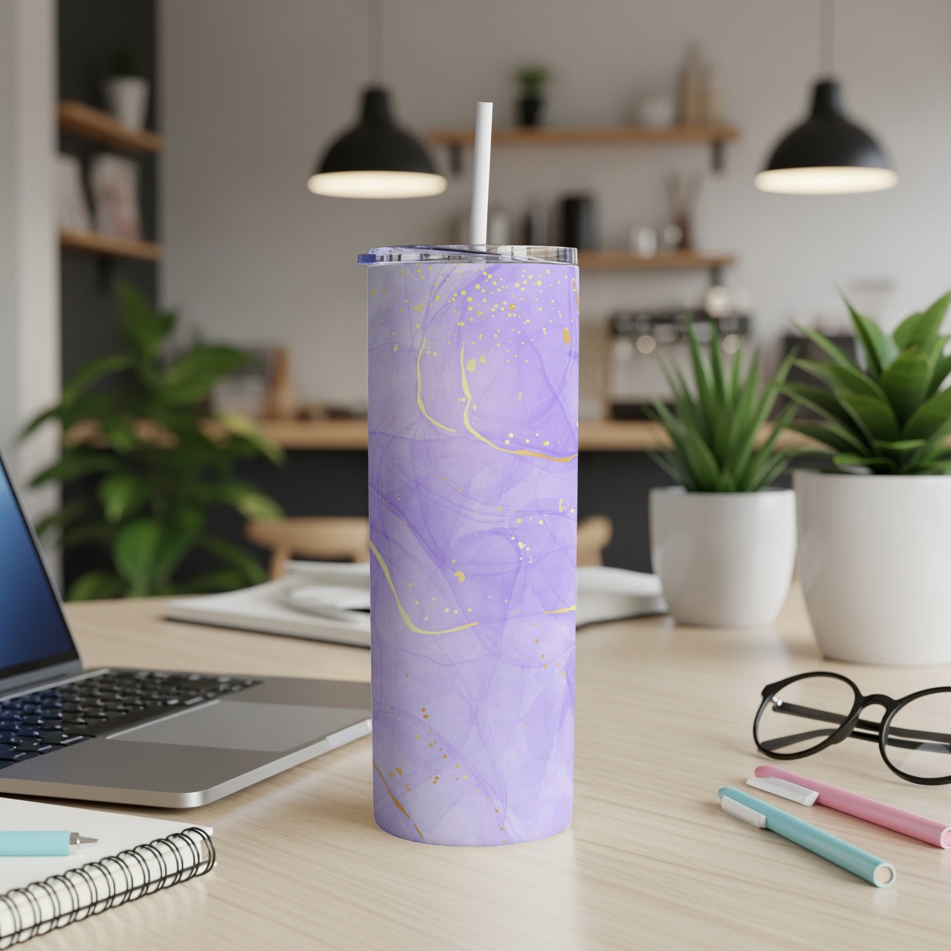 Purple marbled tumbler with gold accents and a straw.