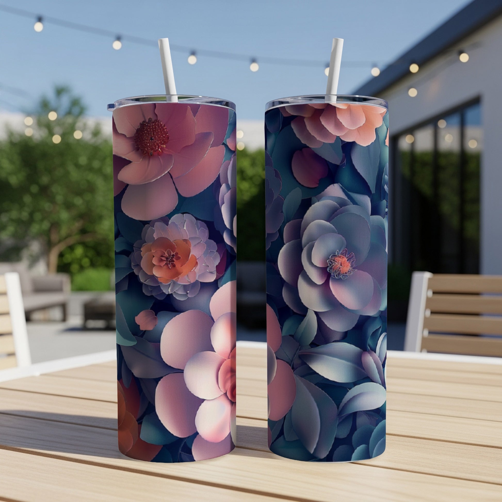 Two tumblers with floral pattern on a wooden table outdoors.