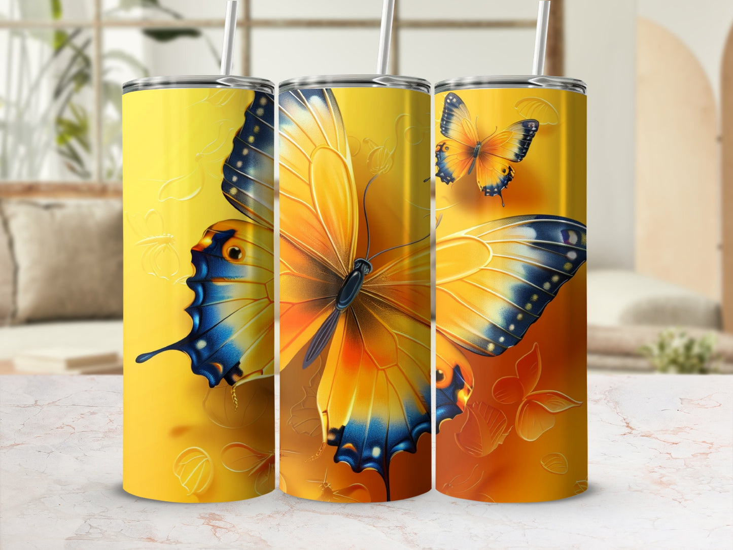 Three tumblers adorned with vibrant orange and blue butterfly designs.