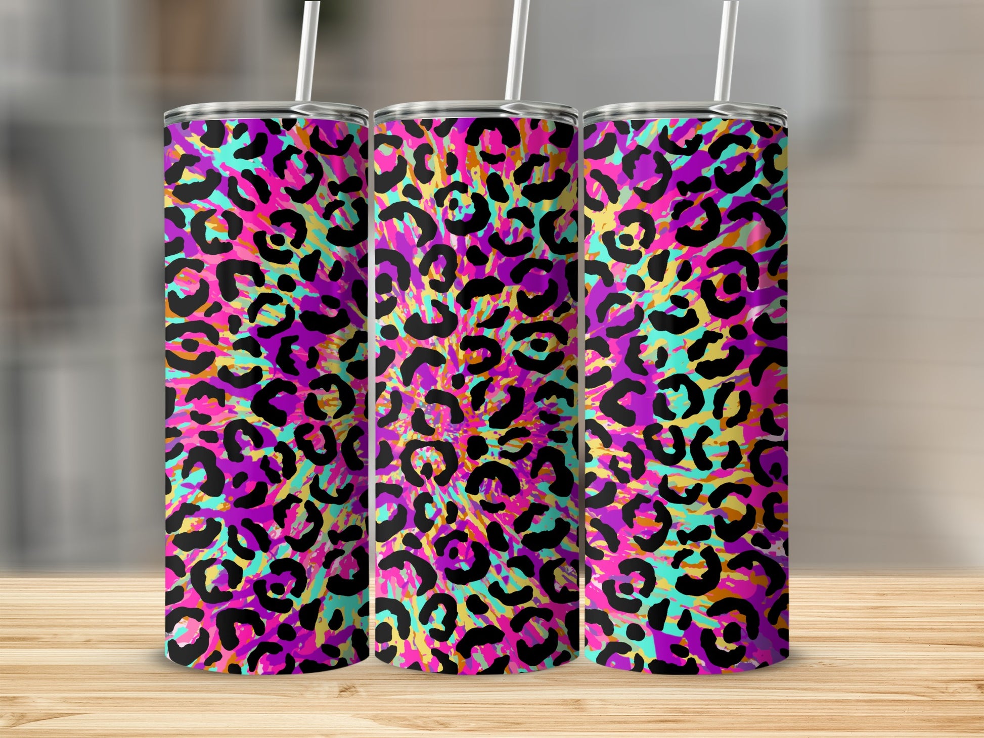Three tumblers with a vibrant, abstract leopard print pattern.
