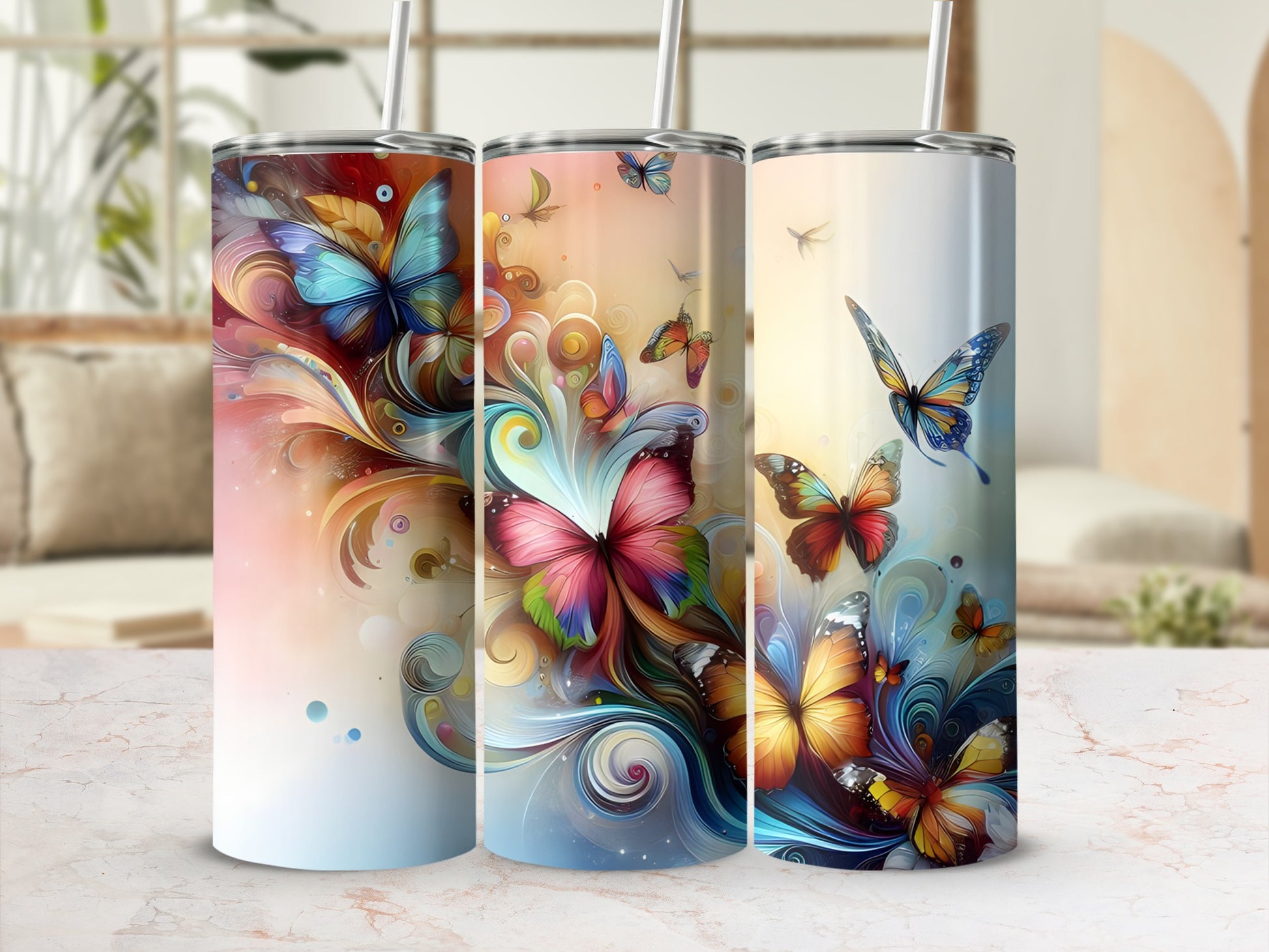 Three tumblers with colorful swirling butterflies and floral designs.