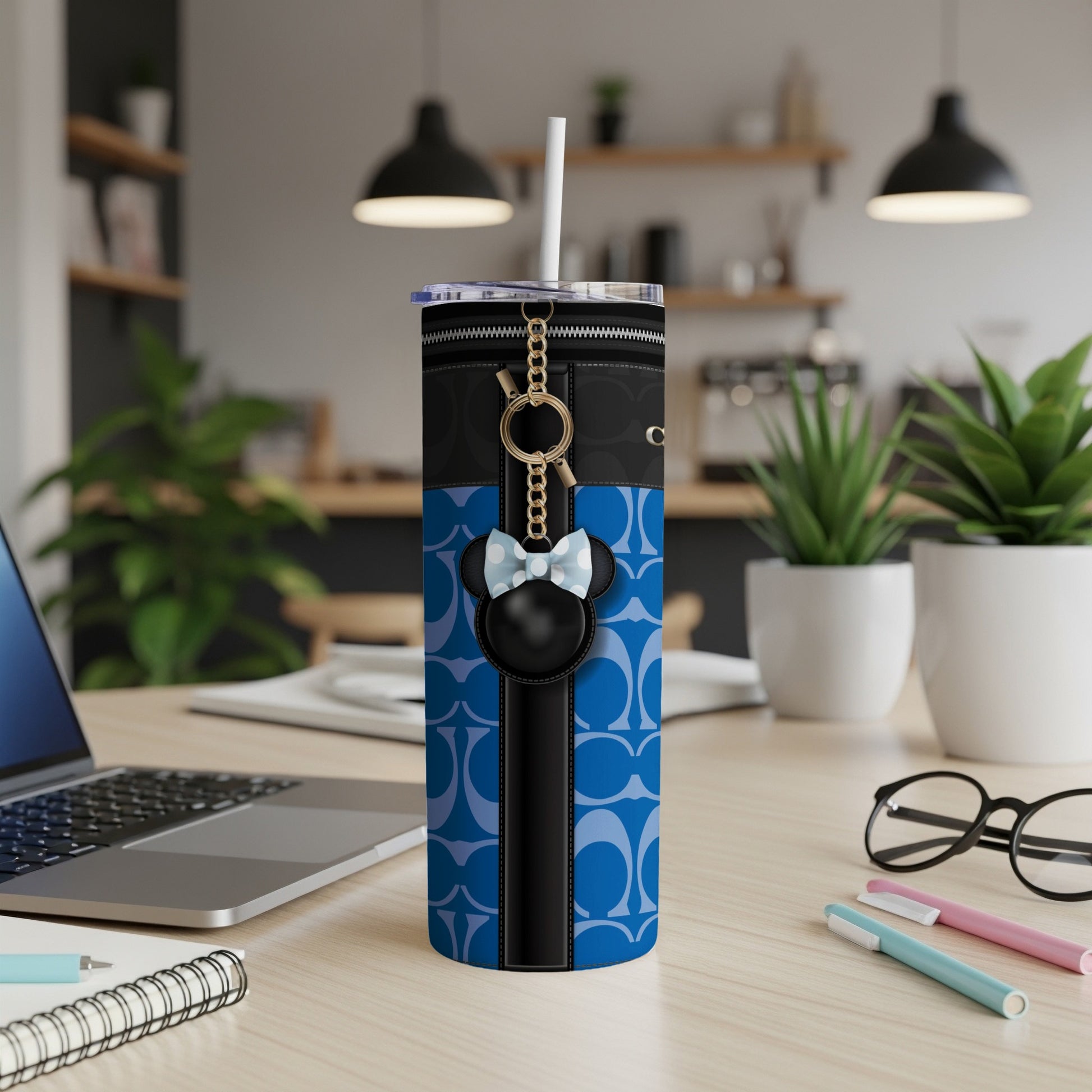 Tumbler with blue C pattern, black zipper detail, and Minnie Mouse keychain charm.