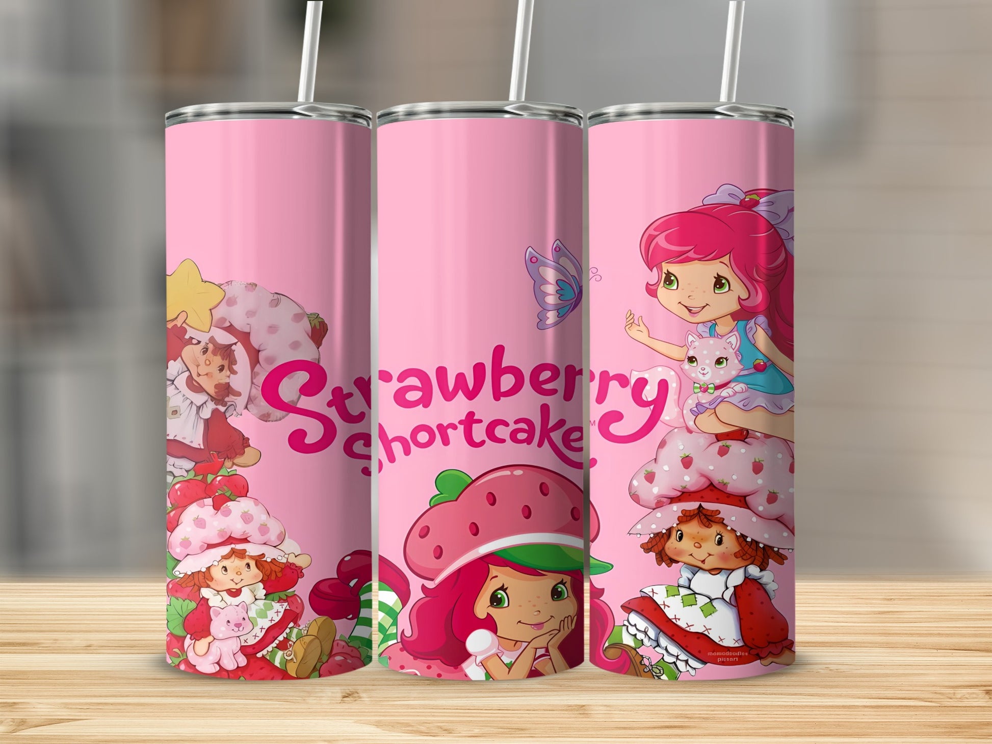 Strawberry Shortcake characters on a pink tumbler with butterfly and strawberries.