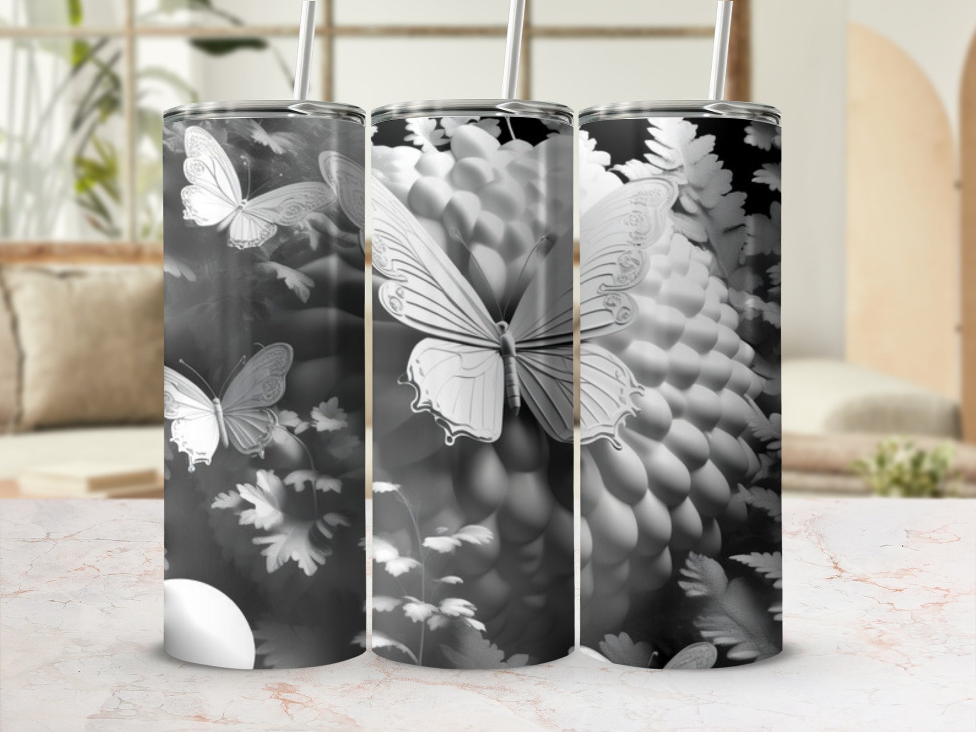 Triptych of tumblers featuring a grayscale butterfly and floral design.